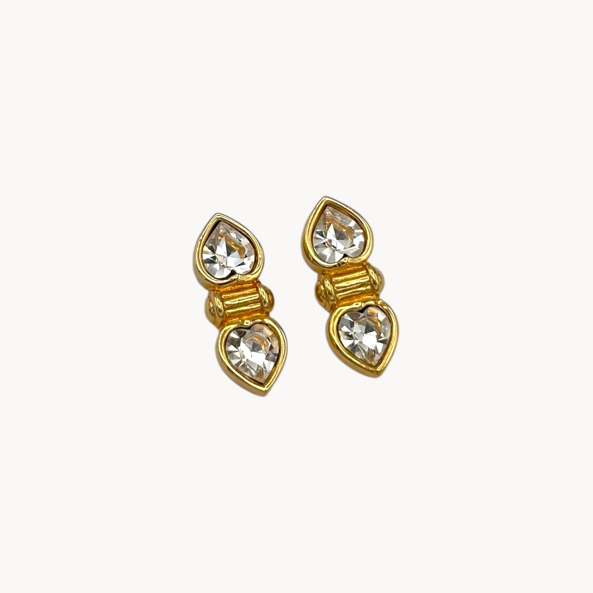 Close up view of Vintage Swarovski SAL clear double heart rhinestone pierced earrings.