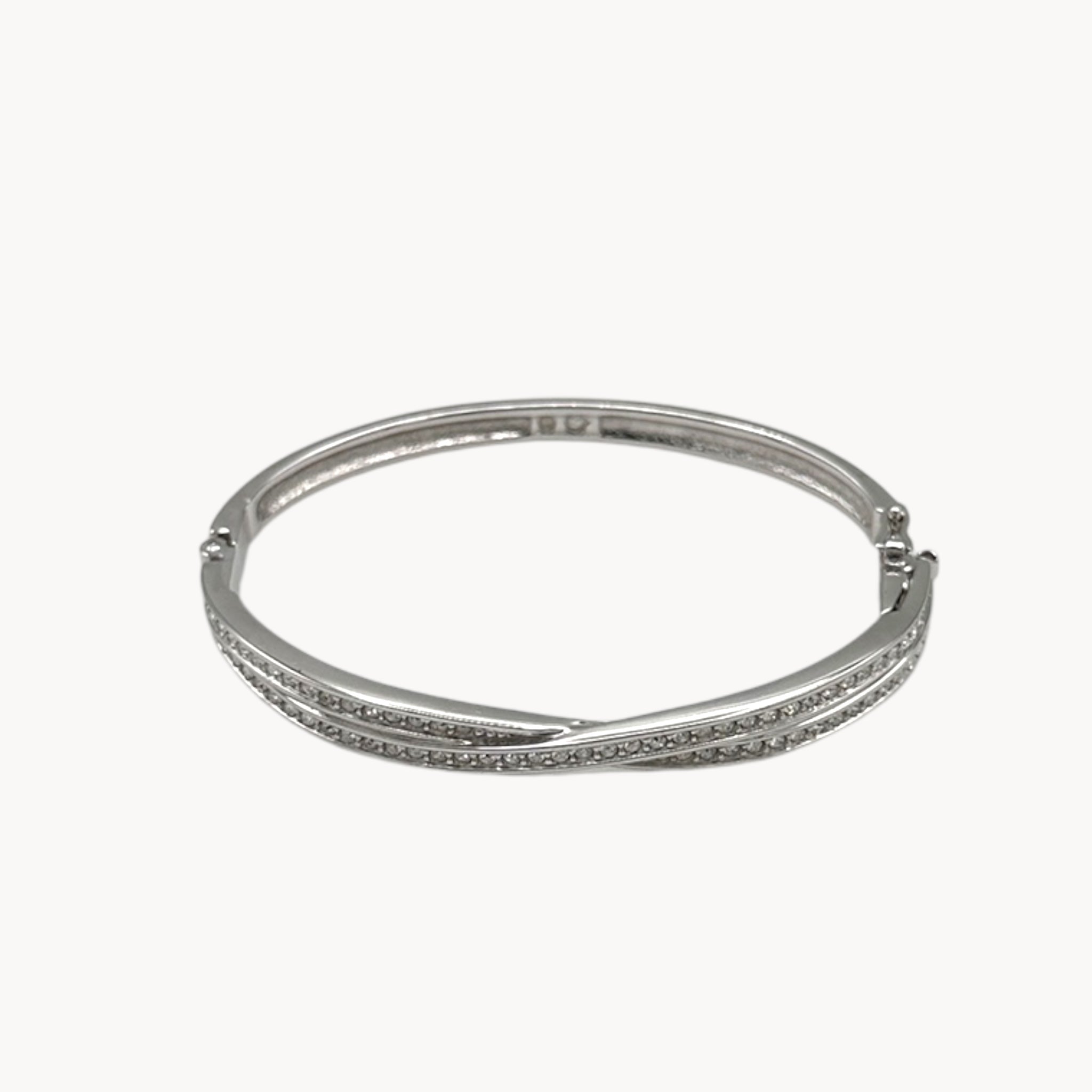 Close up view of Swarovski silver-tone crystal bangle bracelet with elegant sparkling design..