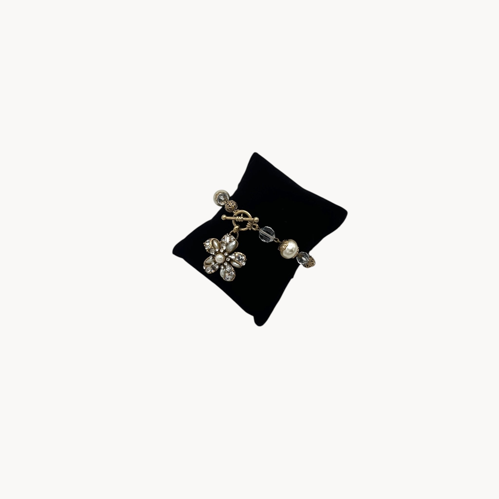 Side view of Sweet Romance floral charm bracelet with pearls and rhinestones