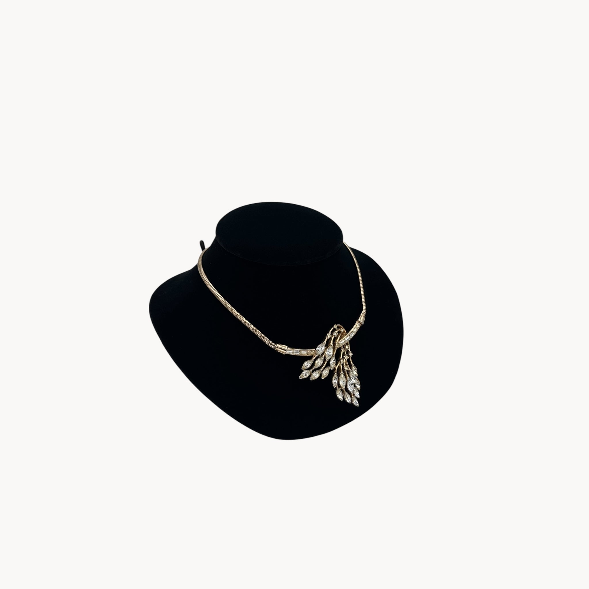 Left side view of 1950s Trifari rhinestone necklace with marquise spray design on snake chain, vintage mid-century bridal jewelry.