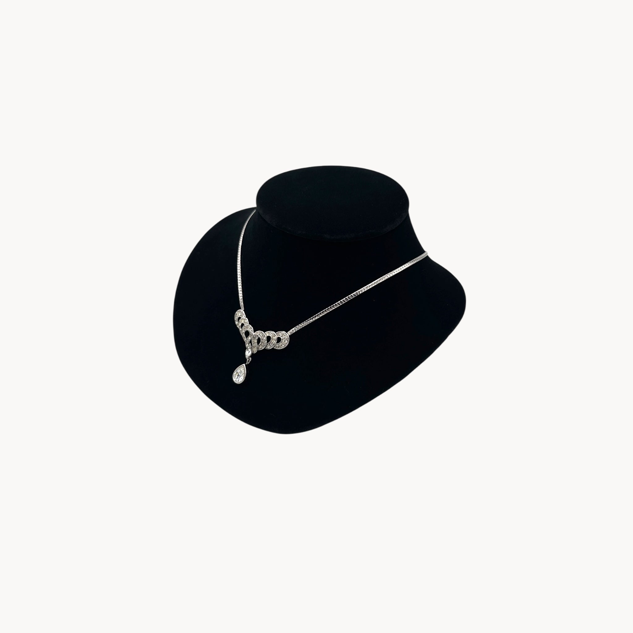 Side view of Trifari 1980s rhinestone necklace with teardrop centerpiece, vintage bridal jewelry