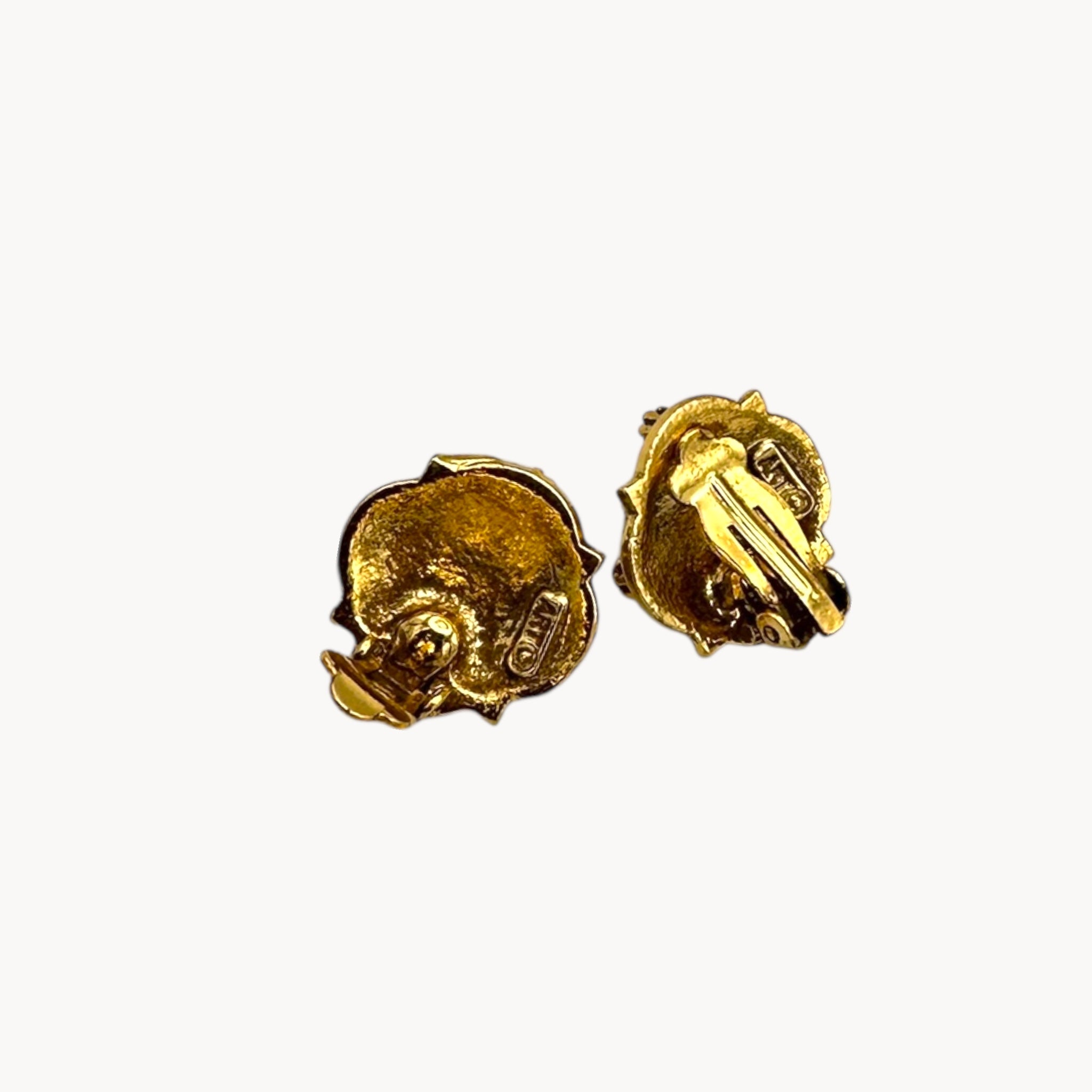 Back view of Victorian revival gold clip-on earrings with faux pearls and purple rhinestones.