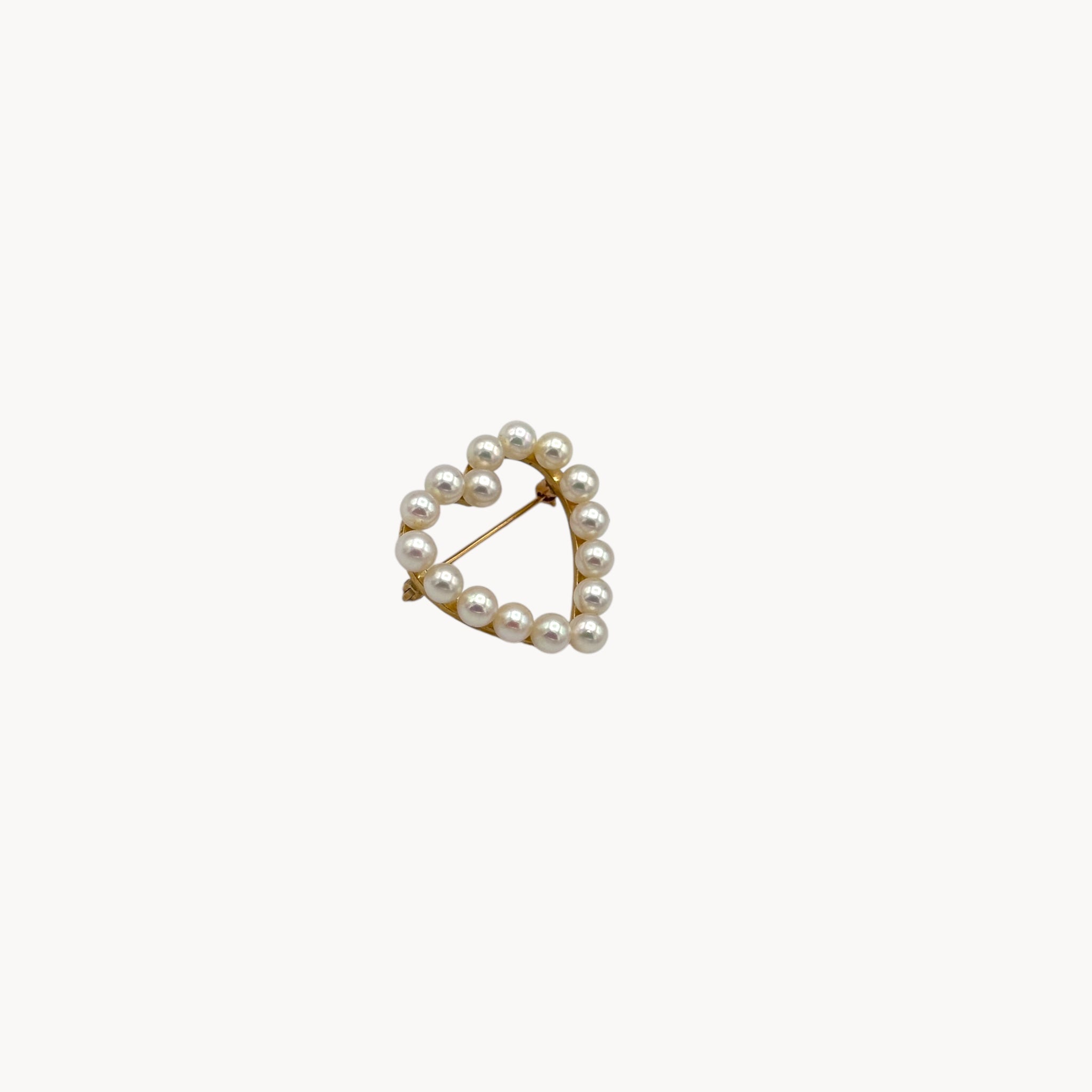 Side view of Vintage 14K gold heart brooch with cultured pearls in a romantic design.