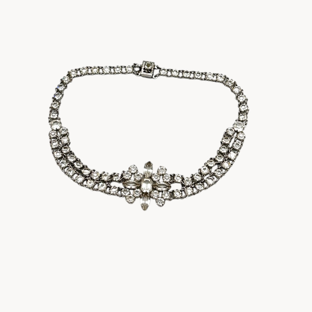 Art Deco crystal necklace on white background.