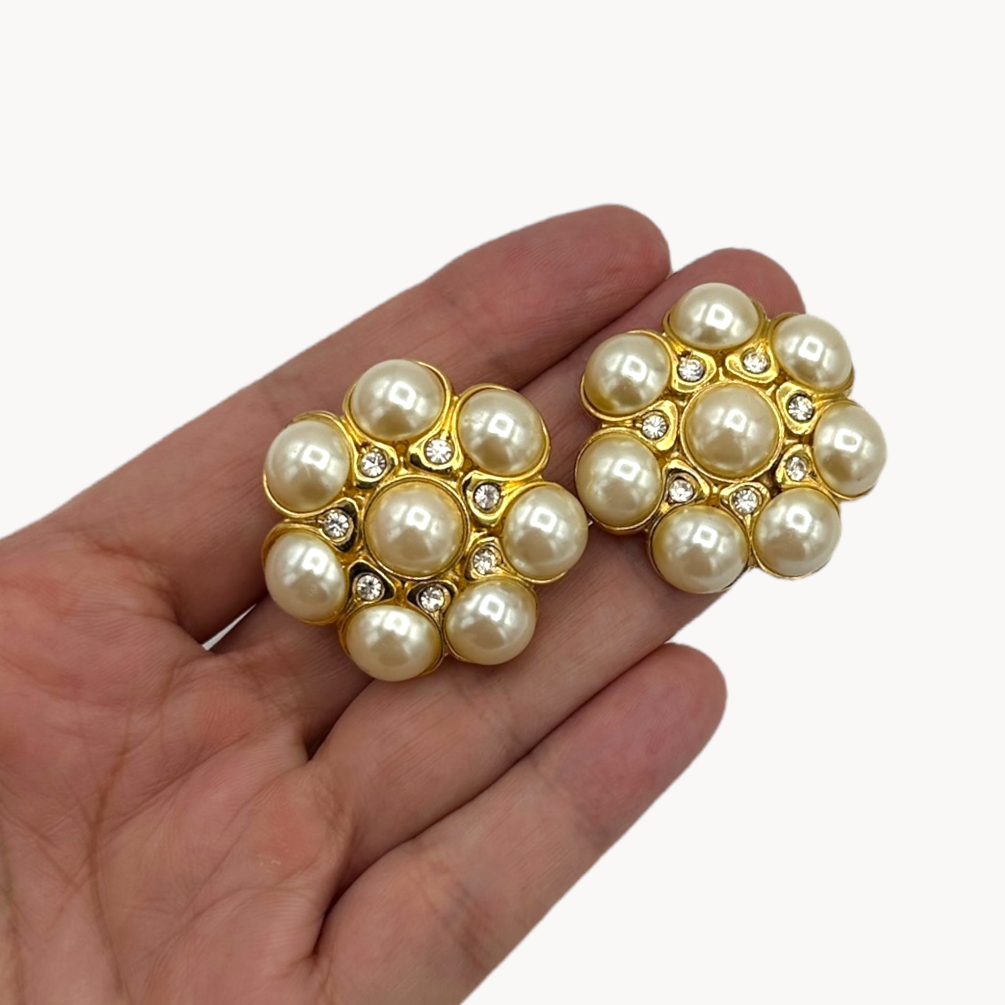 Scale size view Vintage Blanca clip-on earrings with faux pearl cluster and crystal accents in floral design, 1980s–1990s bridal jewelry.