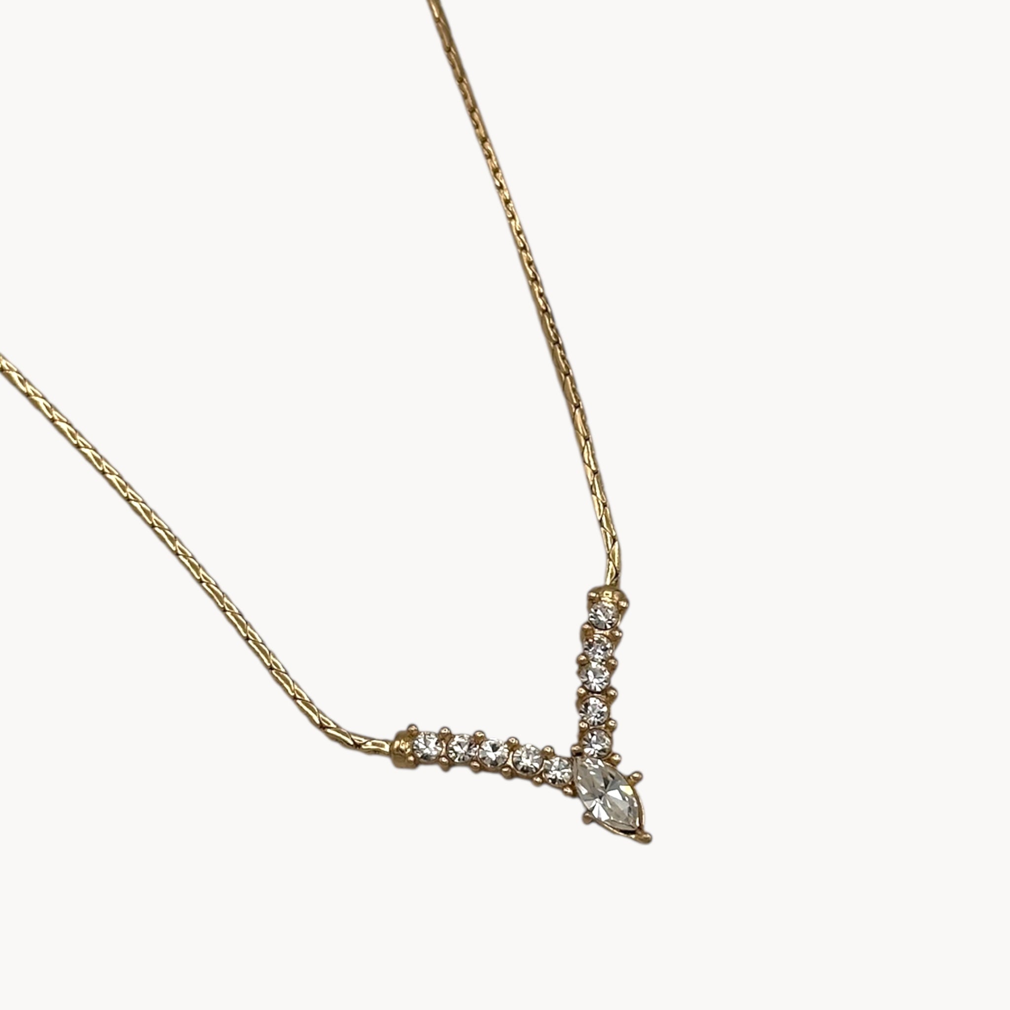 Pendant view Vintage Christian Dior necklace with gold-tone chain and V-shaped crystal pendant, 1990s bridal jewelry.