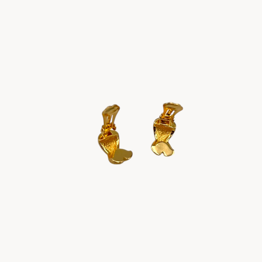Clips open on Vintage Christian Dior petite gold-tone clip-on earrings with rhinestone ribbon detail.
