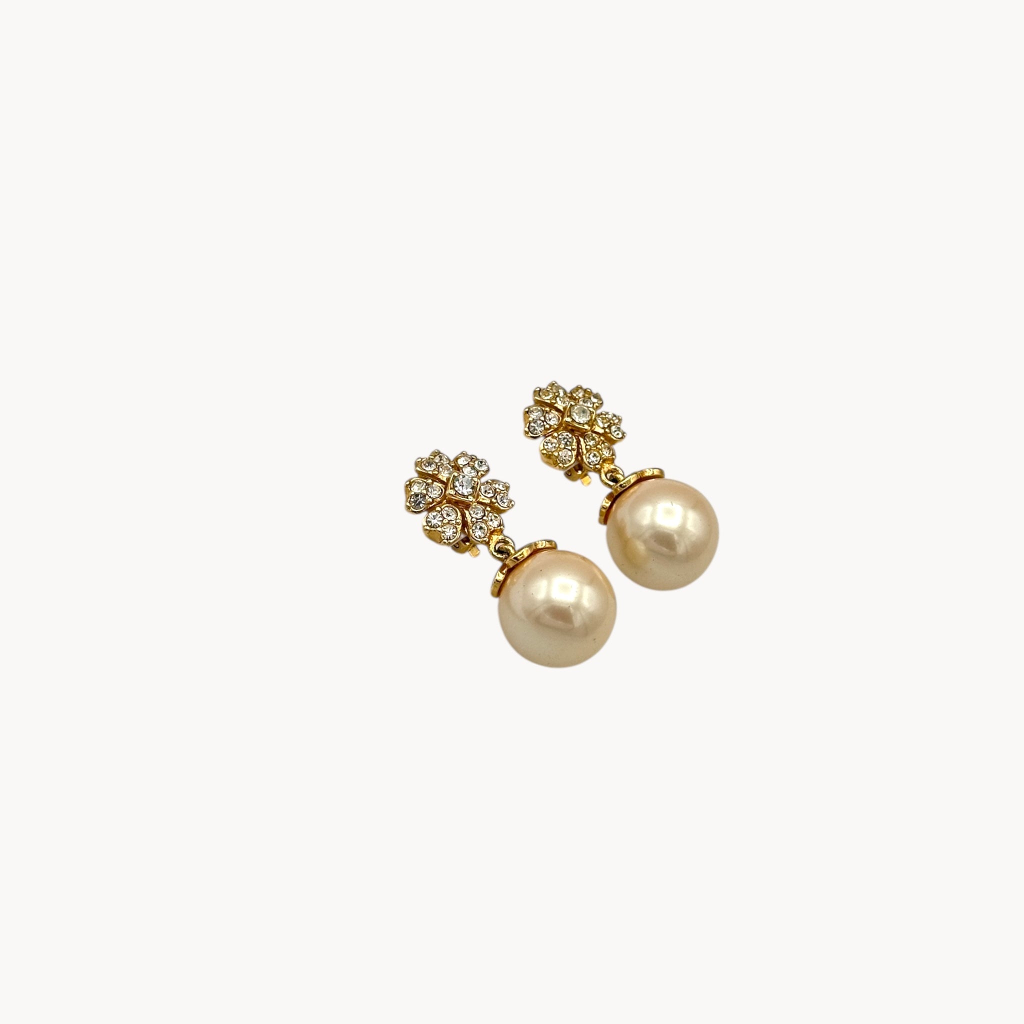 Side view Vintage unmarked clip-on earrings with crystal floral tops and faux pearl drops, 1990s bridal jewelry.