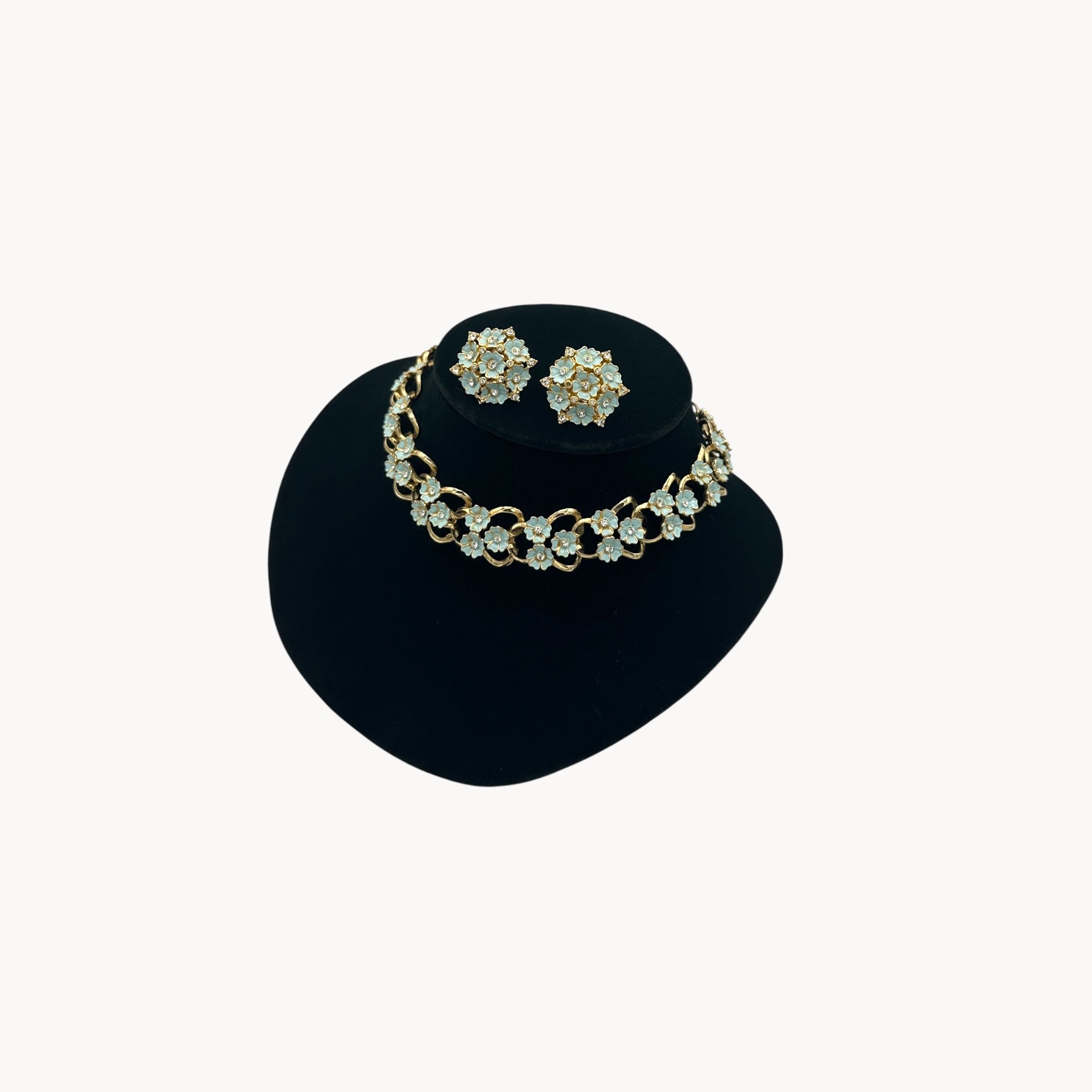 Side view of Vintage mid-century forget-me-not floral necklace and earring set with blue enamel flowers and rhinestones, 1950s bridal jewelry.