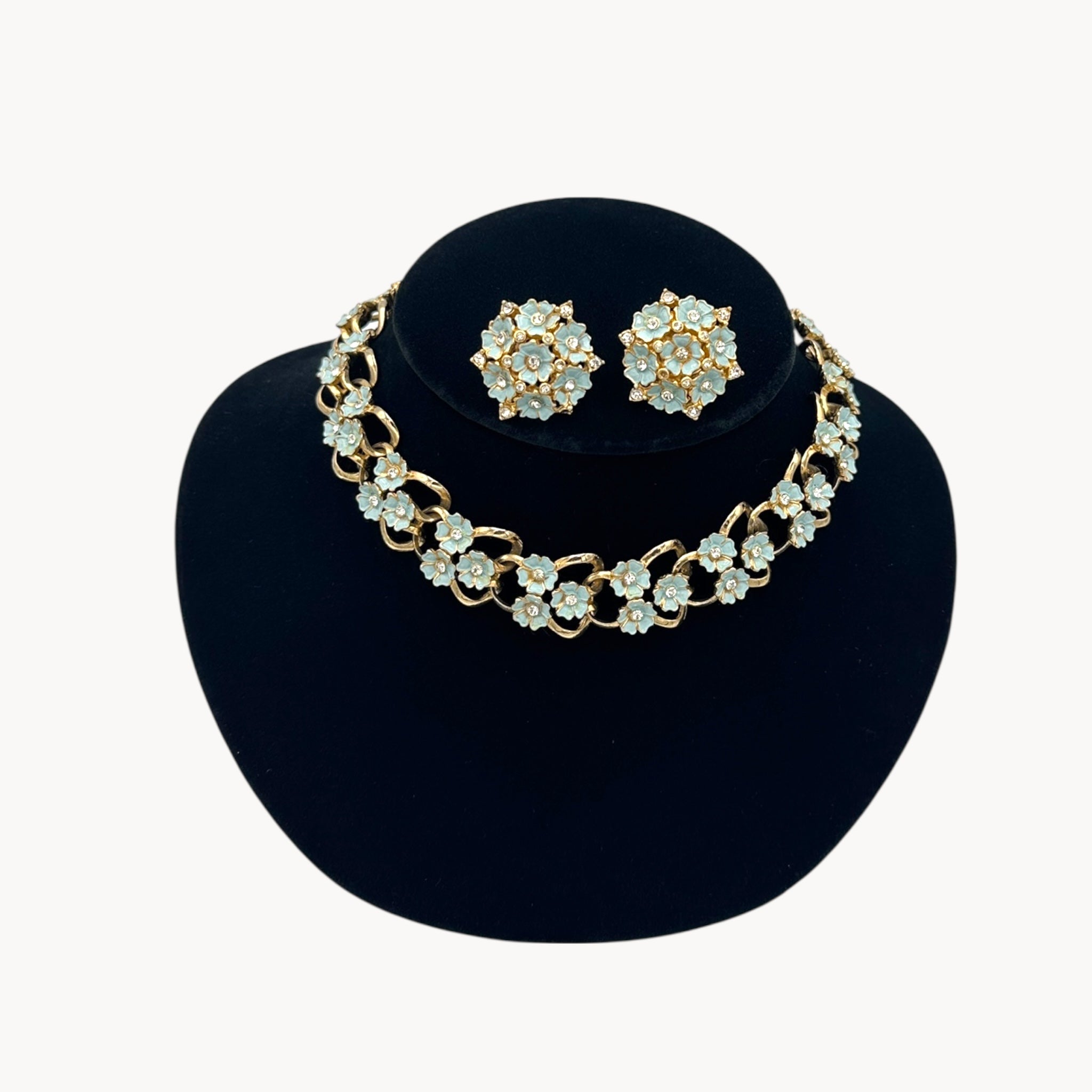 Close up view of Vintage mid-century forget-me-not floral necklace and earring set with blue enamel flowers and rhinestones, 1950s bridal jewelry.
