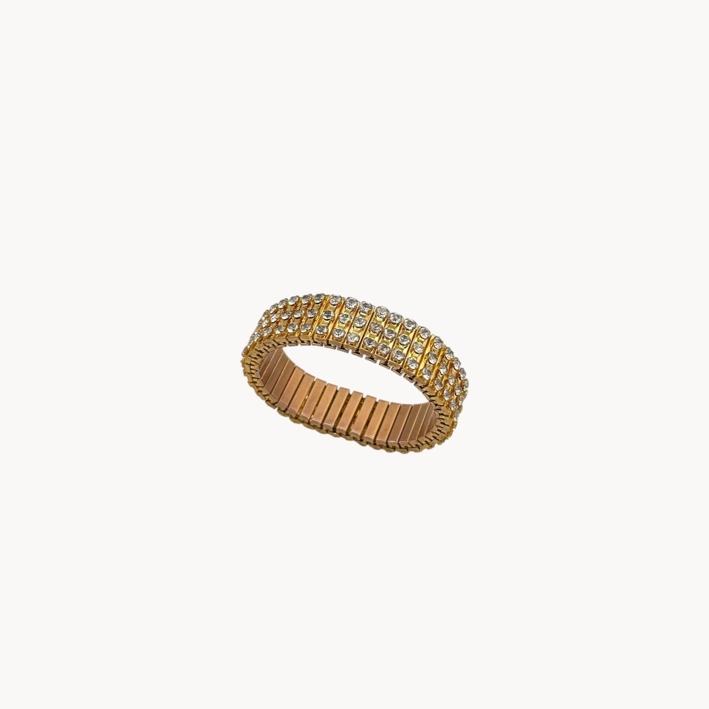 Vintage gold-tone expansion bracelet with three rows of rhinestones, mid-century design.