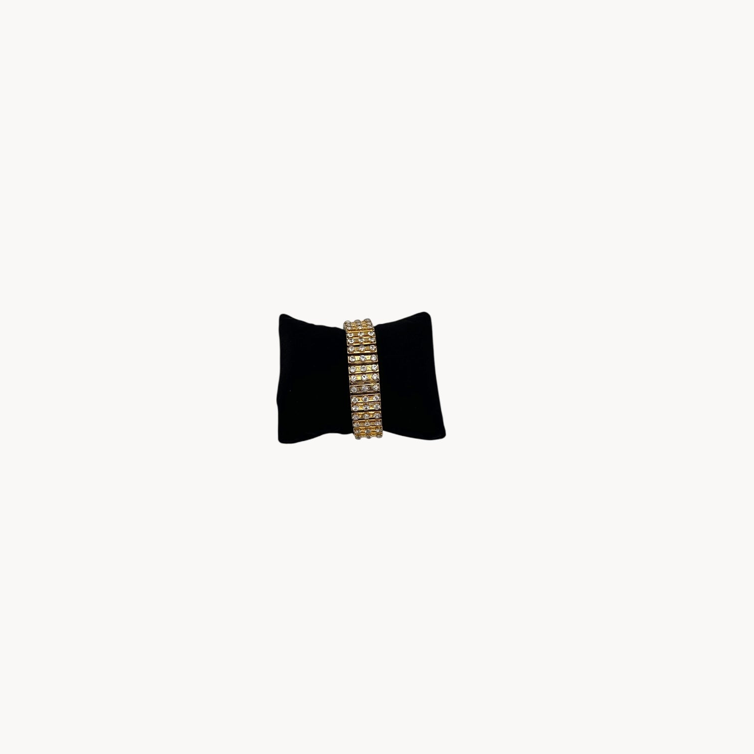 Front view of Vintage gold-tone expansion bracelet with three rows of rhinestones, mid-century design.