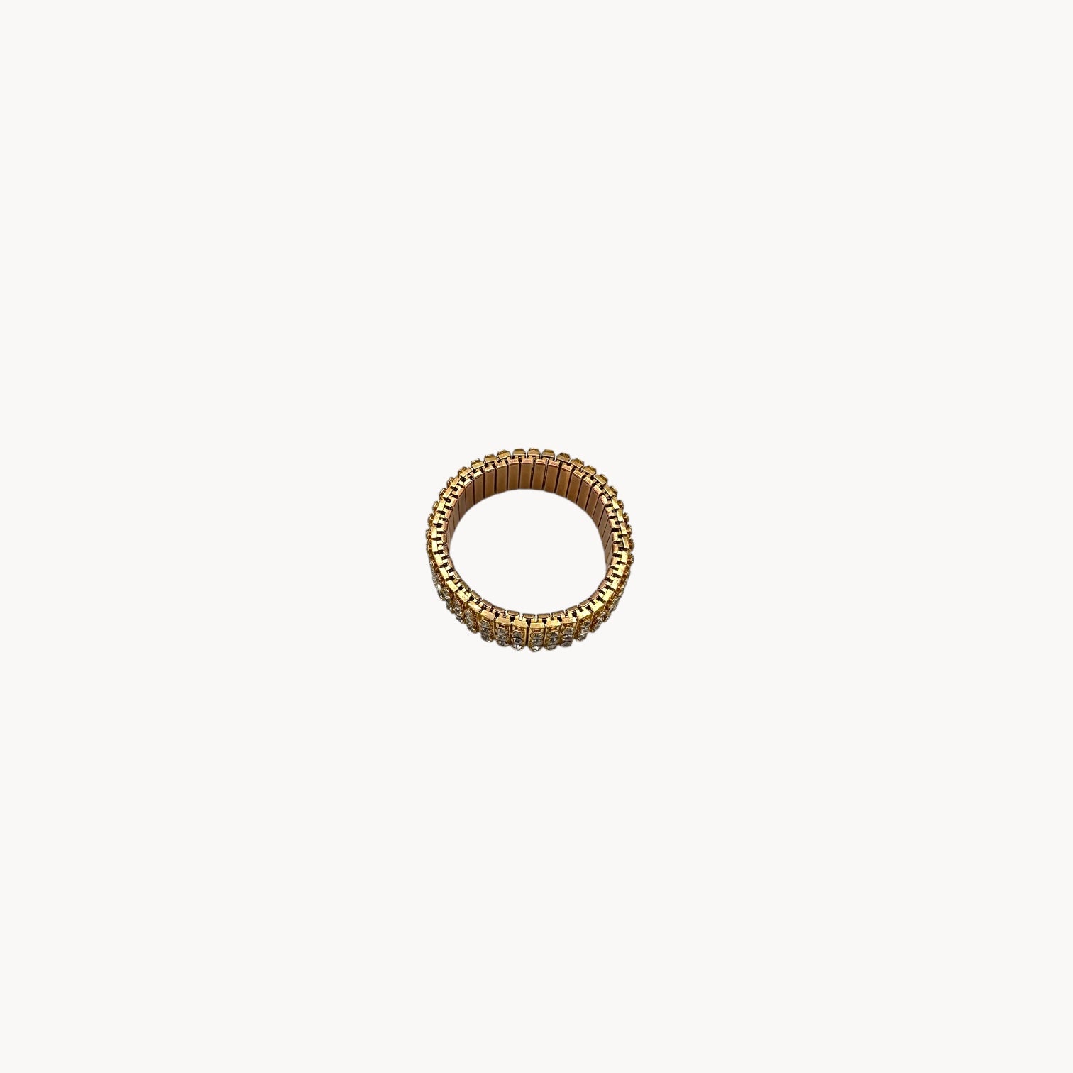 Top view of Vintage gold-tone expansion bracelet with three rows of rhinestones, mid-century design.