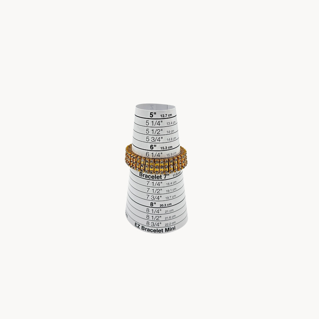 Close up view of Vintage gold-tone expansion bracelet with three rows of rhinestones on sizer.
