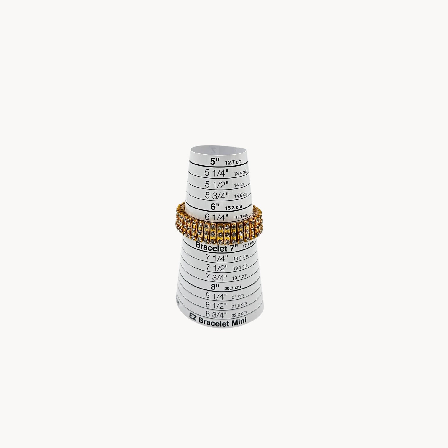 Close up view of Vintage gold-tone expansion bracelet with three rows of rhinestones on sizer.