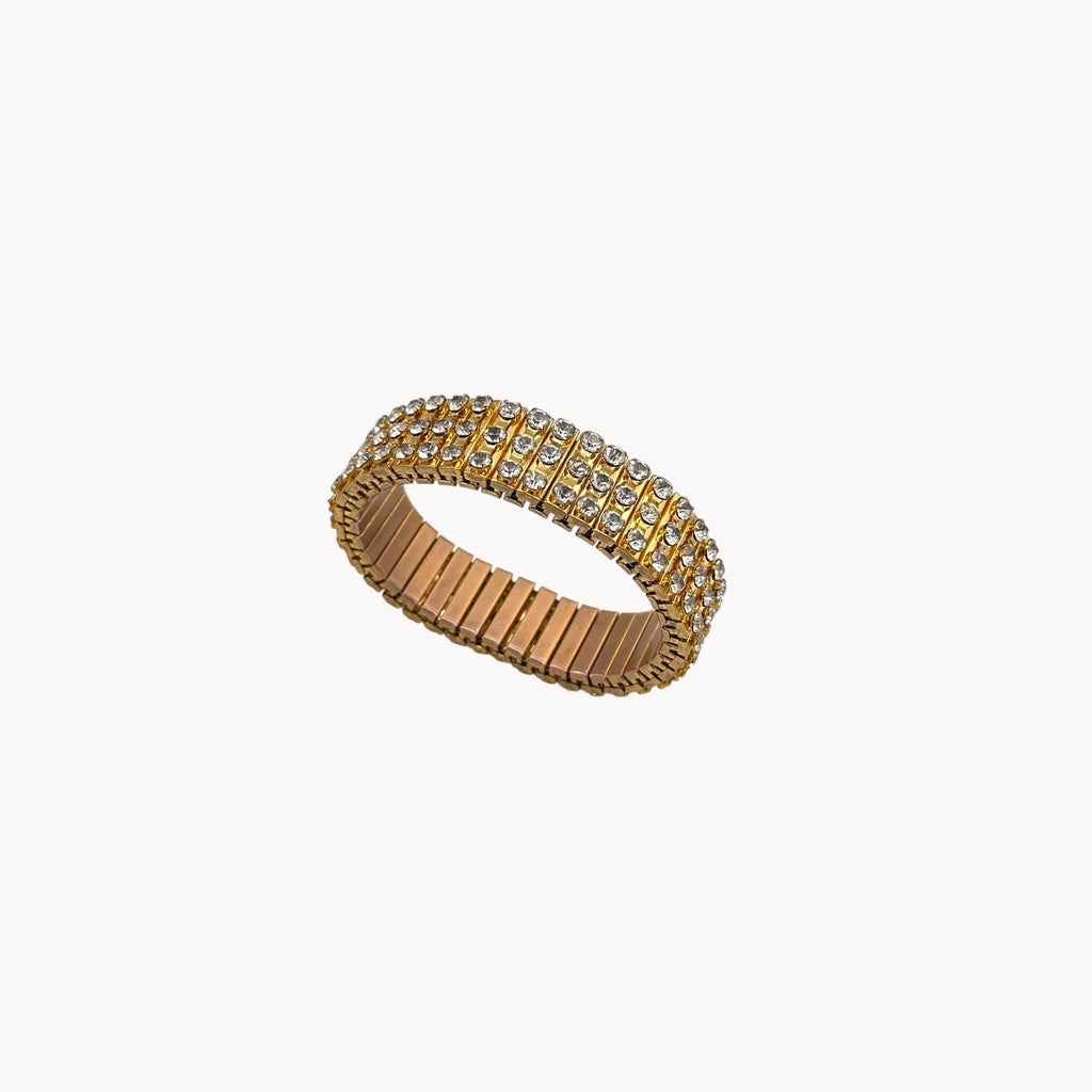 Close up view of Vintage gold-tone expansion bracelet with three rows of rhinestones, mid-century design.