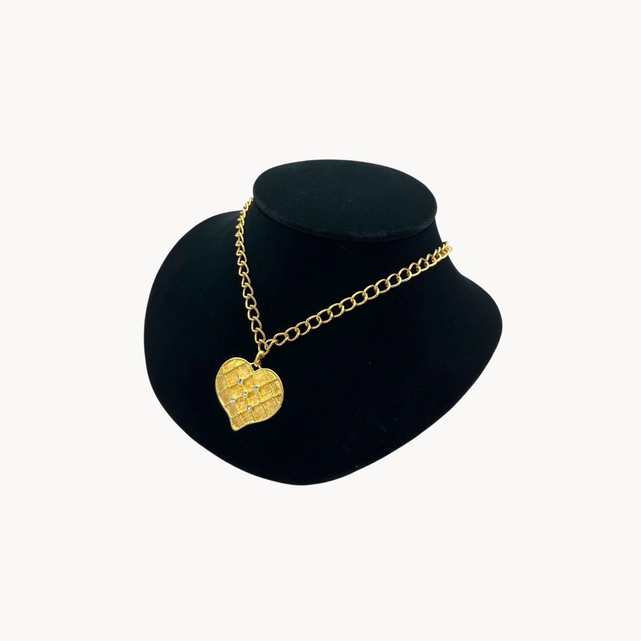 Side view of Vintage gold heart pendant necklace with rhinestone accents on a chunky chain.