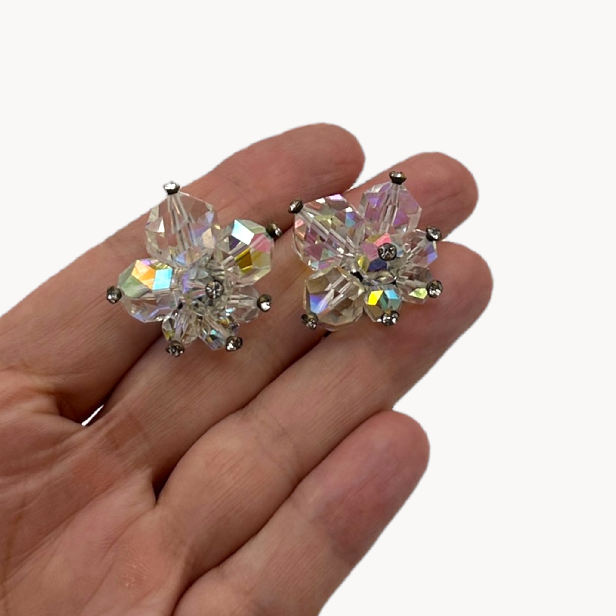 Scale size view 1950s Laguna crystal cluster clip-on earrings with aurora borealis finish, vintage bridal jewelry
