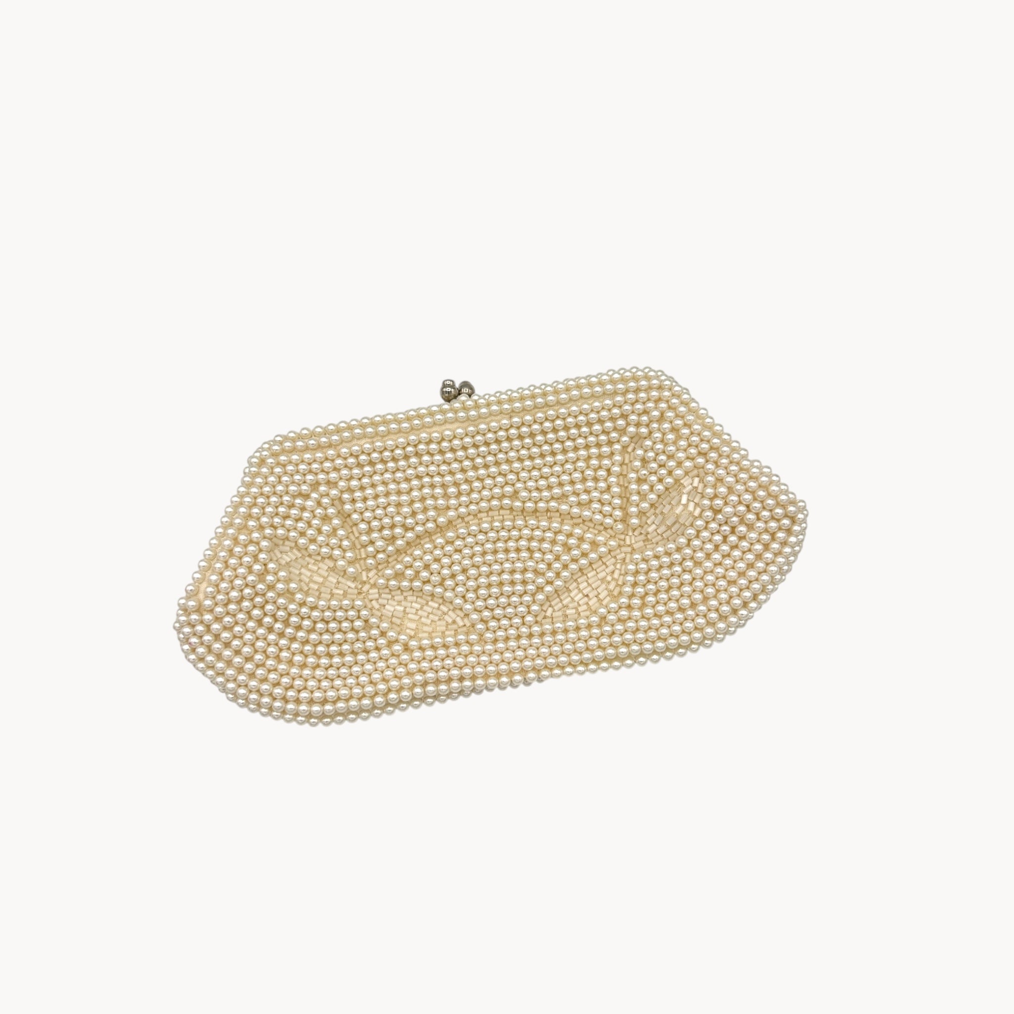 Side view of Vintage Made in Japan small pearl beaded clutch handbag, 1950 bridal purse on white background.