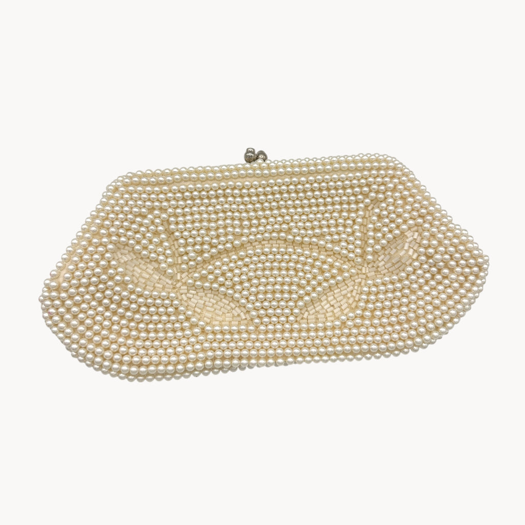 Close up view of front of Vintage Made in Japan small pearl beaded clutch handbag, 1950 bridal purse on white background.