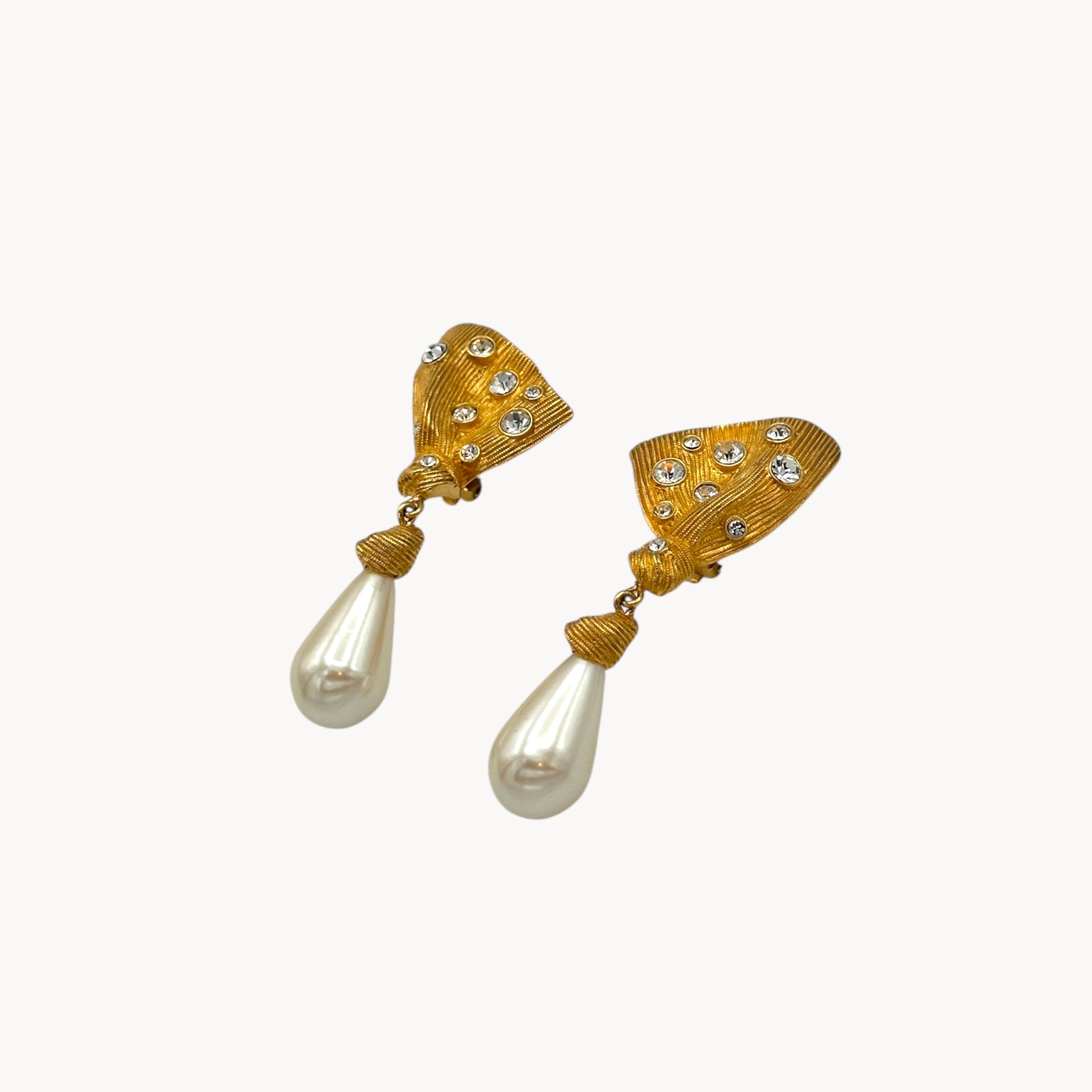 side view Vintage Marvella clip-on earrings with gold fan-shaped tops, crystal accents, and faux pearl drops, 1980s bridal jewelry.
