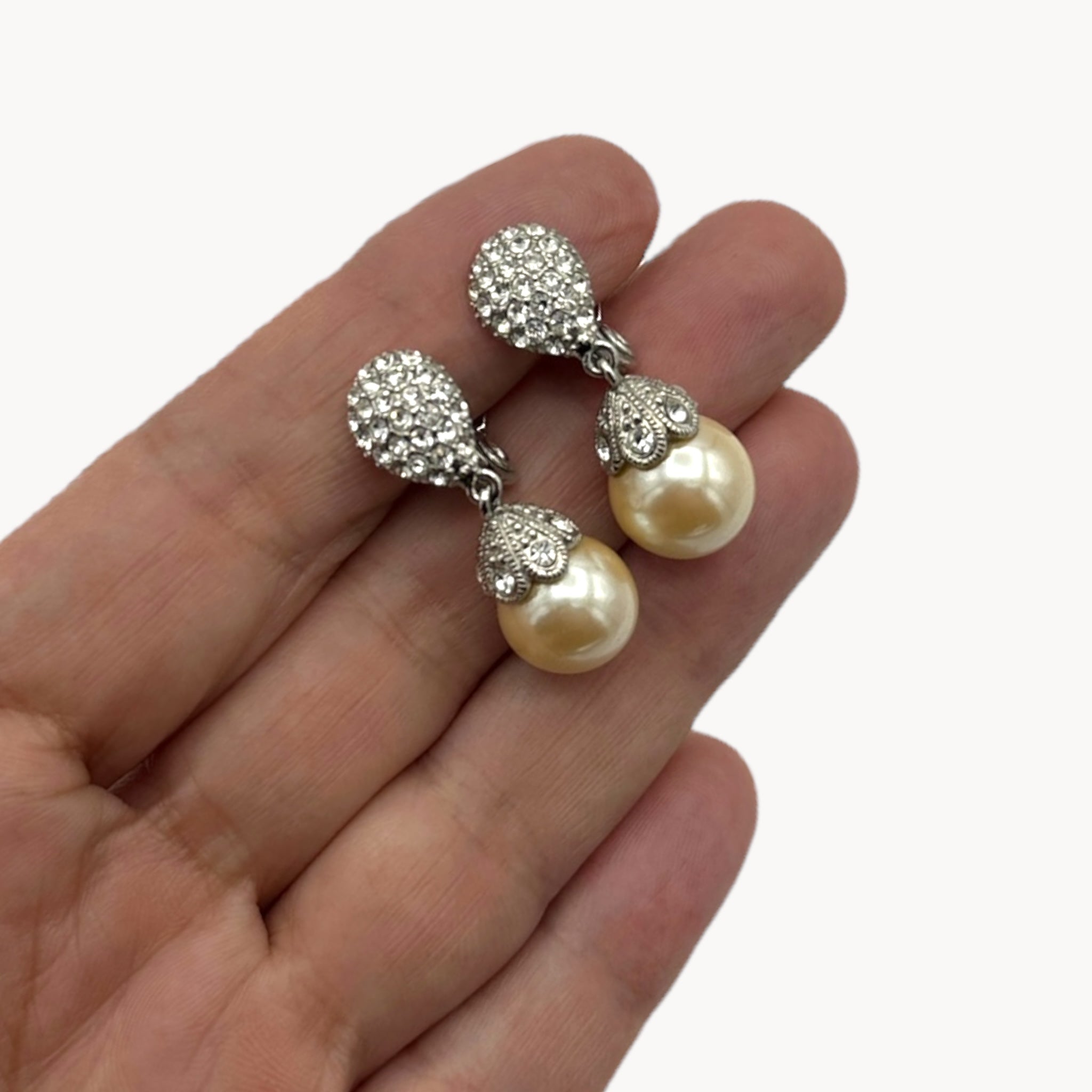 Scale size view Vintage Monet clip-on earrings with faux pearls and pavé crystal accents, 1980s–1990s bridal jewelry.