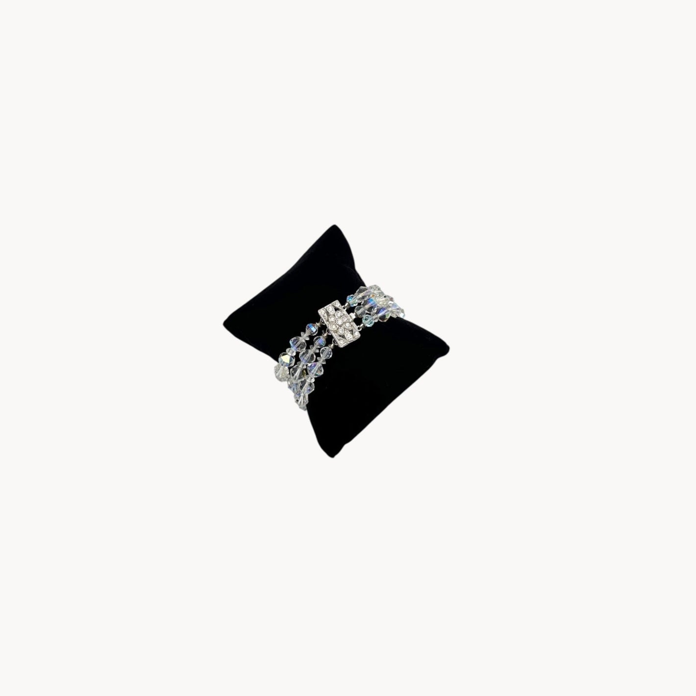 Top view of Vintage unsigned multi-strand faceted crystal bracelet with rhinestone clasp in Art Deco style.