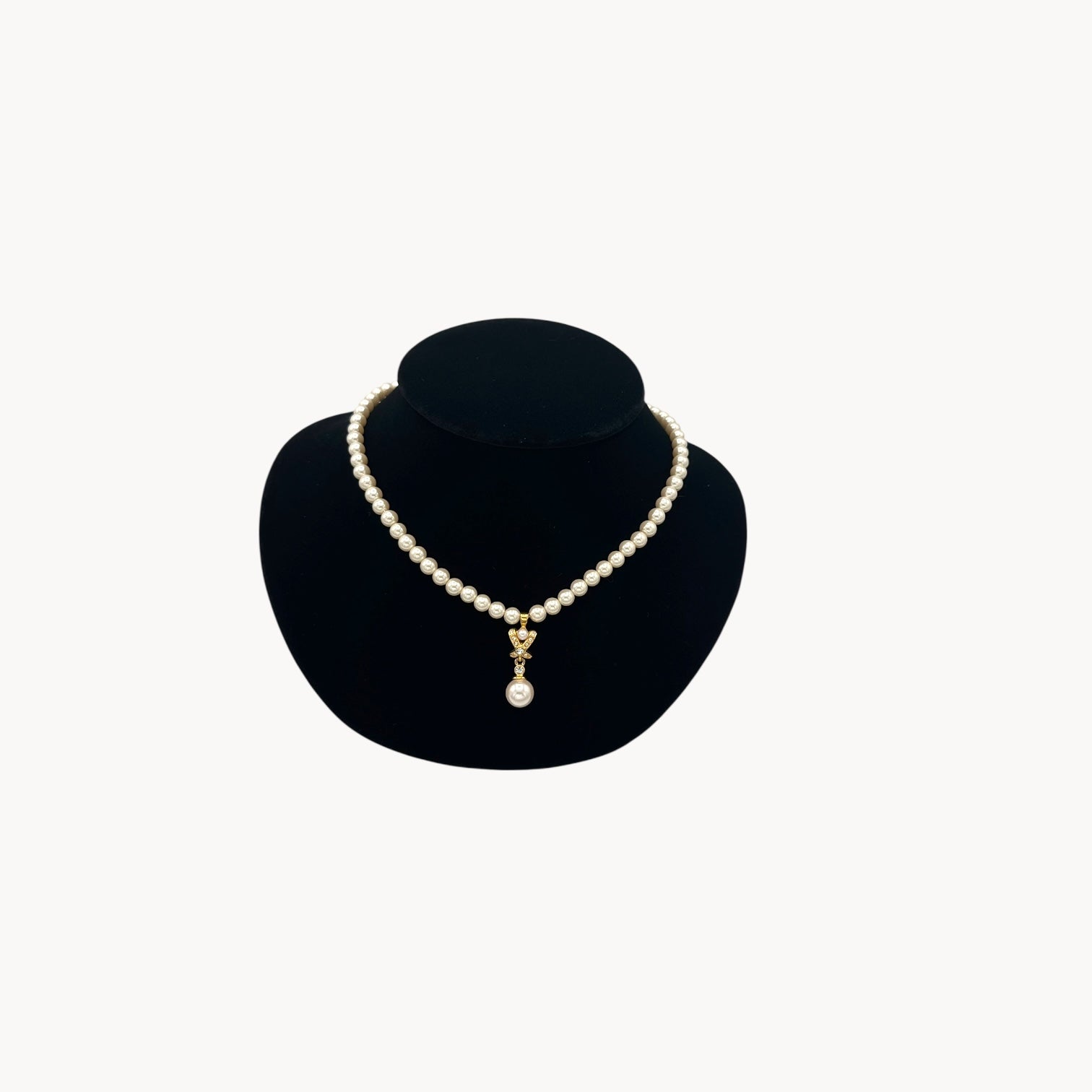Vintage Napier faux pearl necklace with rhinestone X motif and pearl drop pendant.
