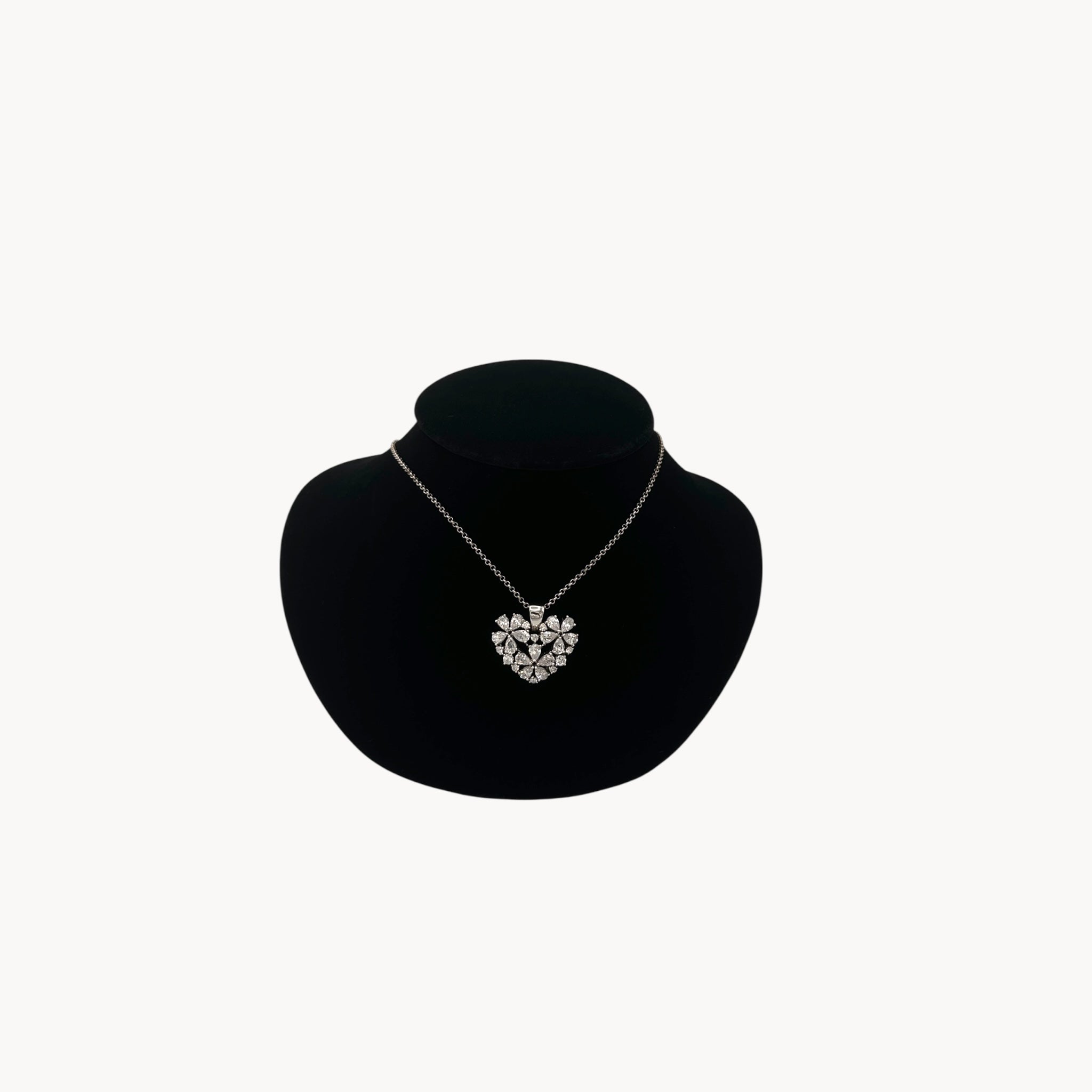 Vintage Nolan Miller rhinestone heart pendant necklace on silver chain.