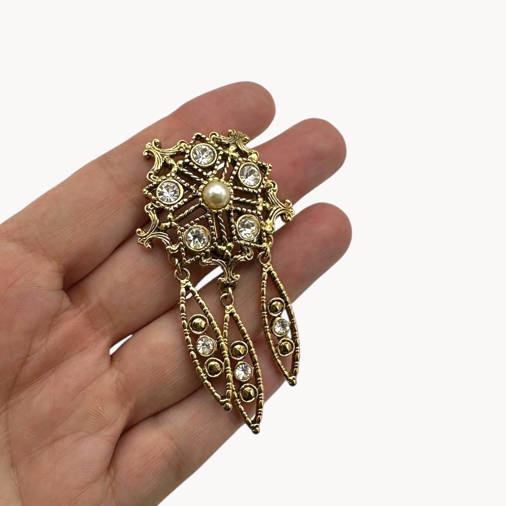 Scale view of Vintage pearl and rhinestone drop brooch with three dangles in Victorian revival style