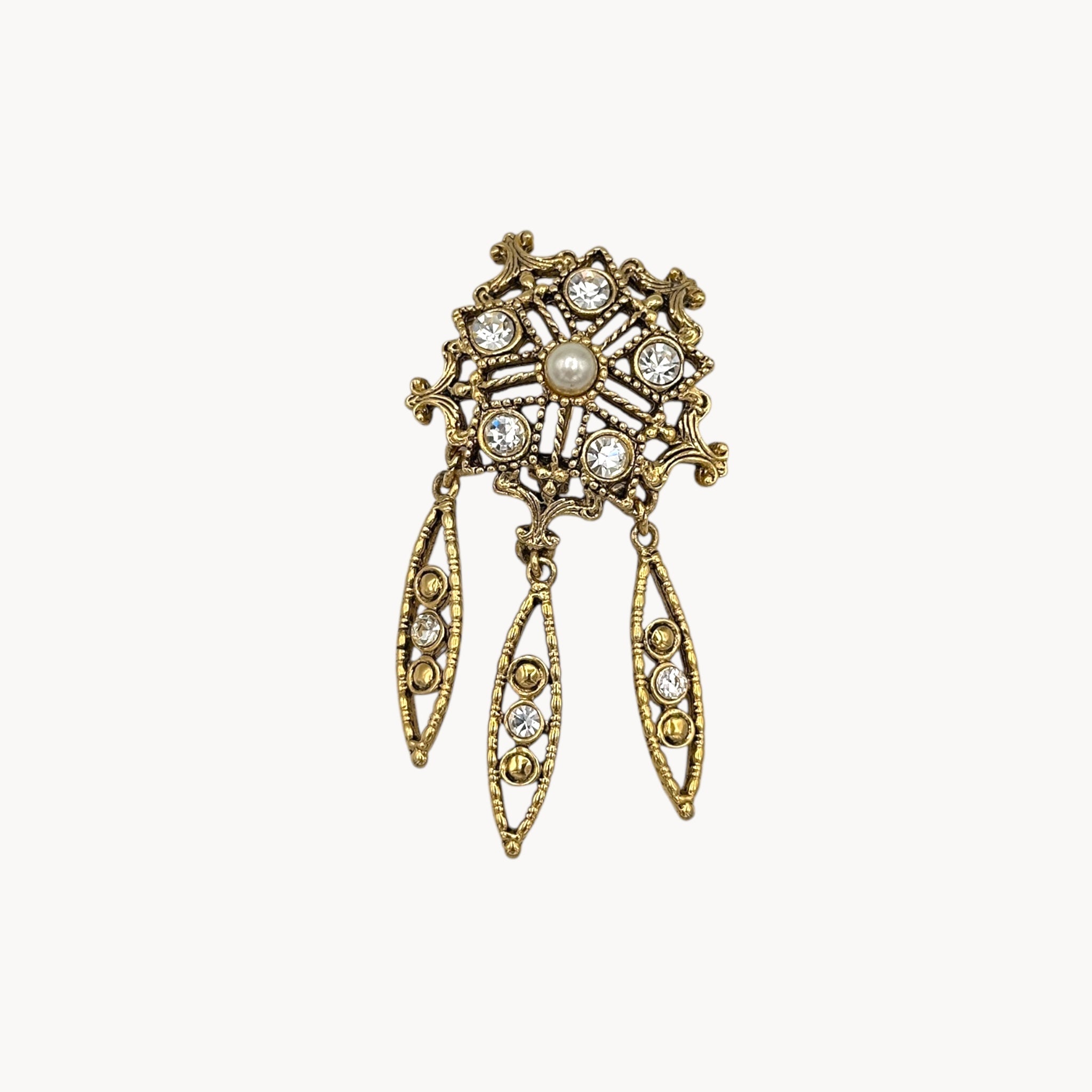 Close up view of Vintage pearl and rhinestone drop brooch with three dangles in Victorian revival style