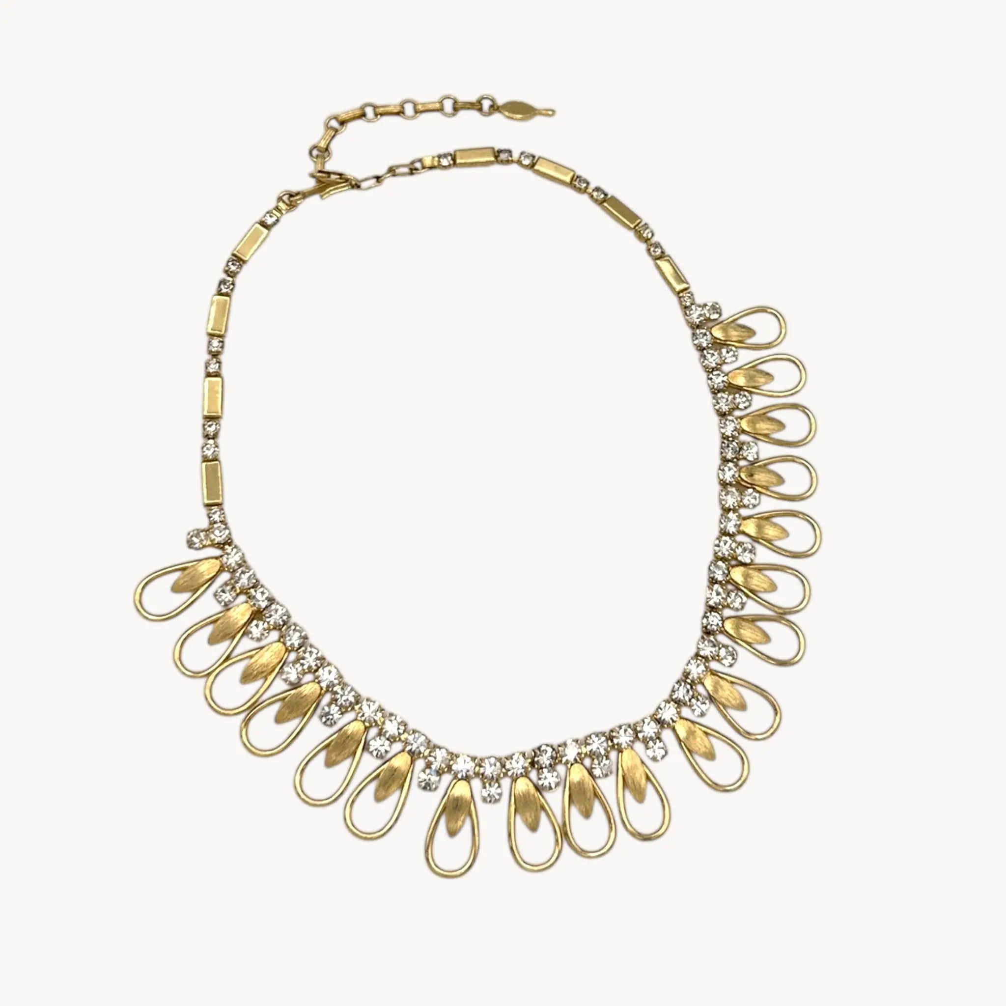 Vintage Sarah Coventry gold-tone teardrop bib necklace with clear rhinestones displayed on white background.
