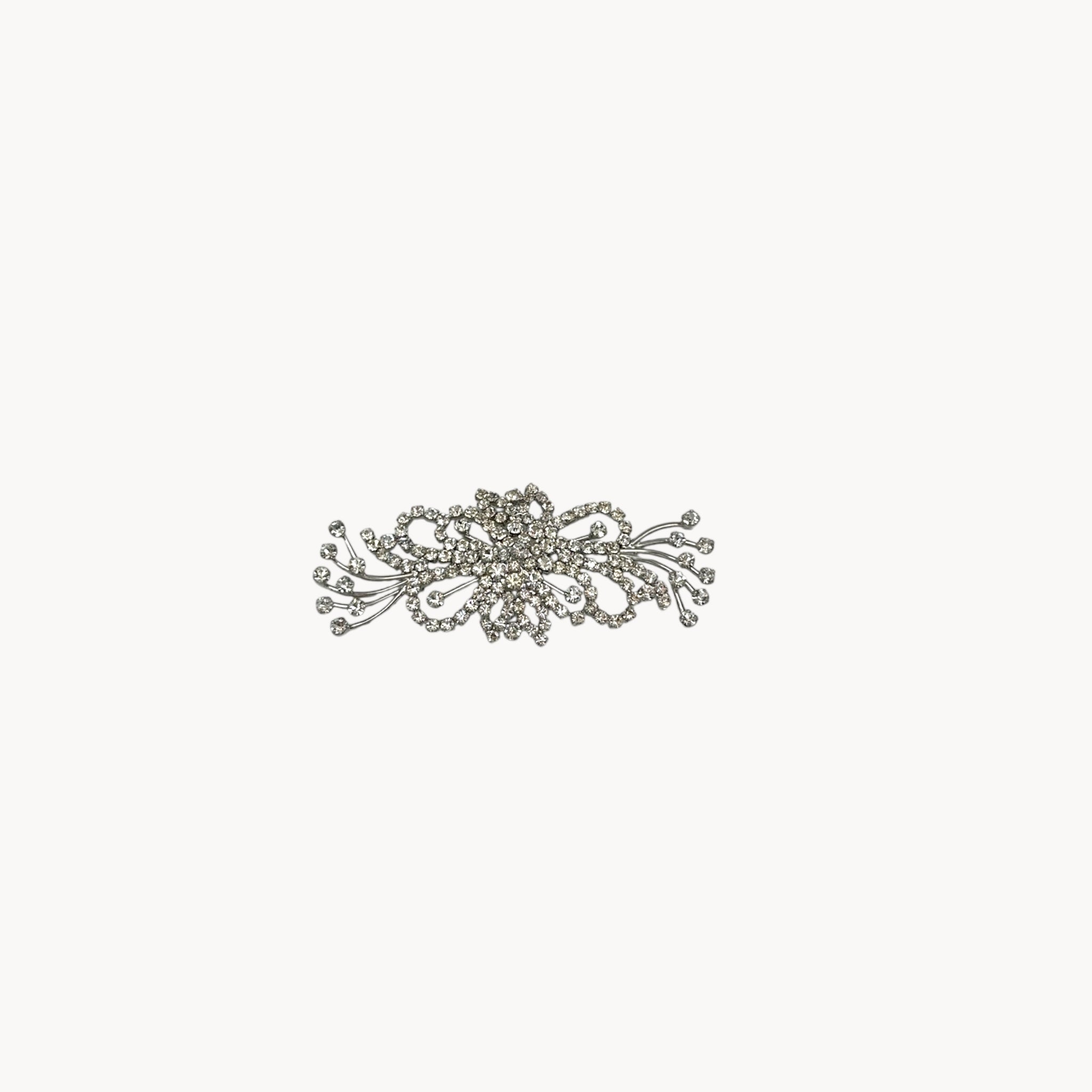 Large vintage rhinestone spray brooch with prong-set stones and rhodium plating, mid-century design.