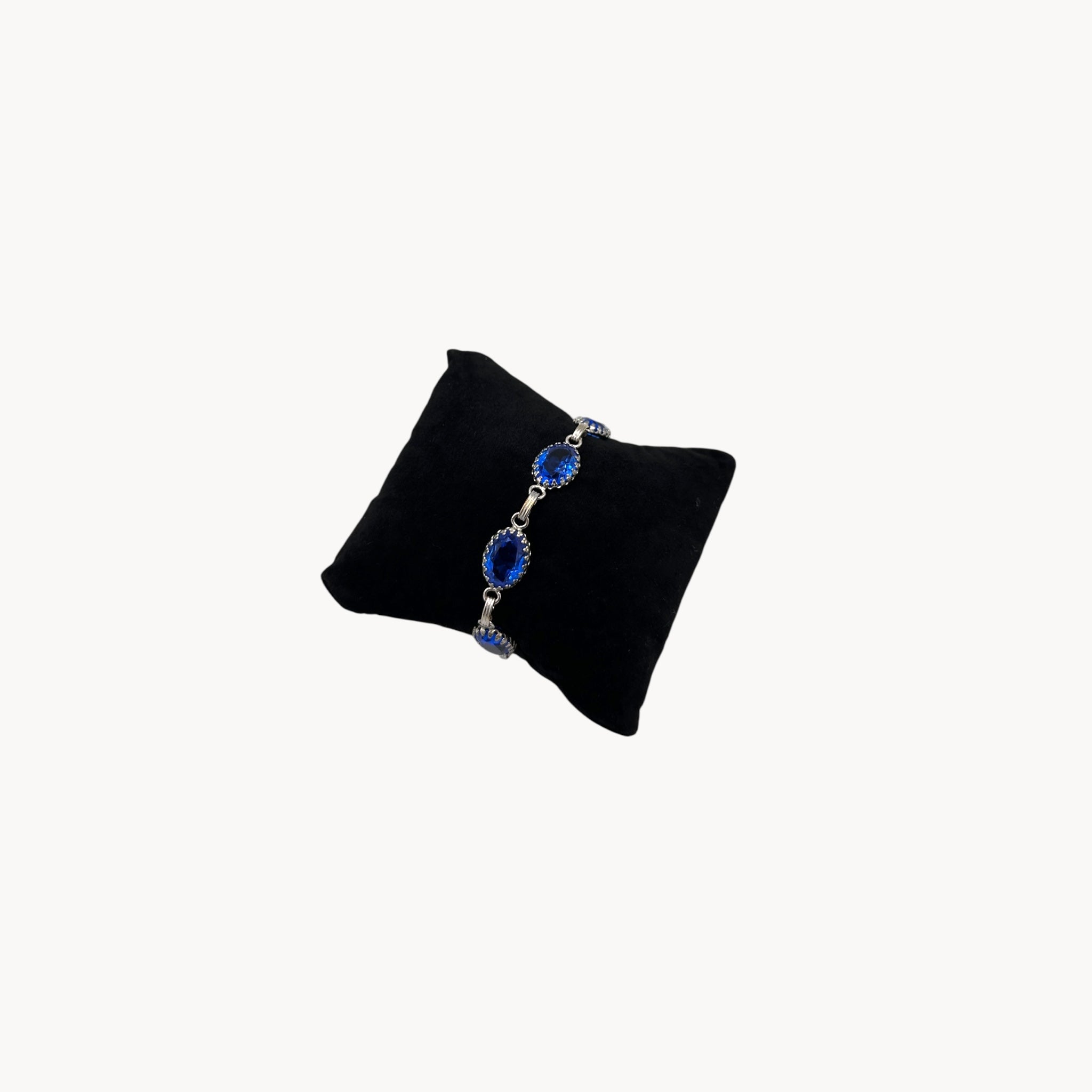 Vintage sterling silver blue glass link bracelet with oval sapphire-toned stones, mid-century bridal jewelry.