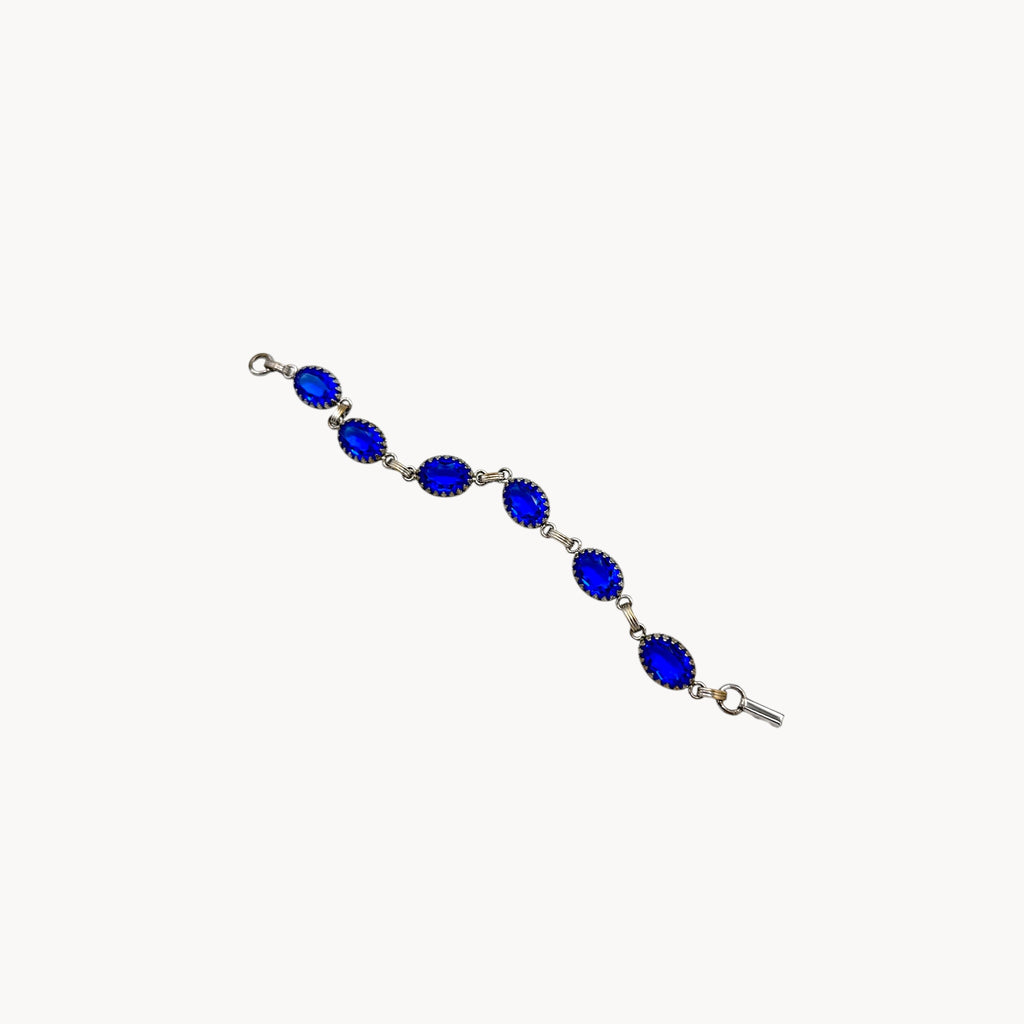 Extended view of Vintage sterling silver blue glass link bracelet with oval sapphire-toned stones, mid-century bridal jewelry.