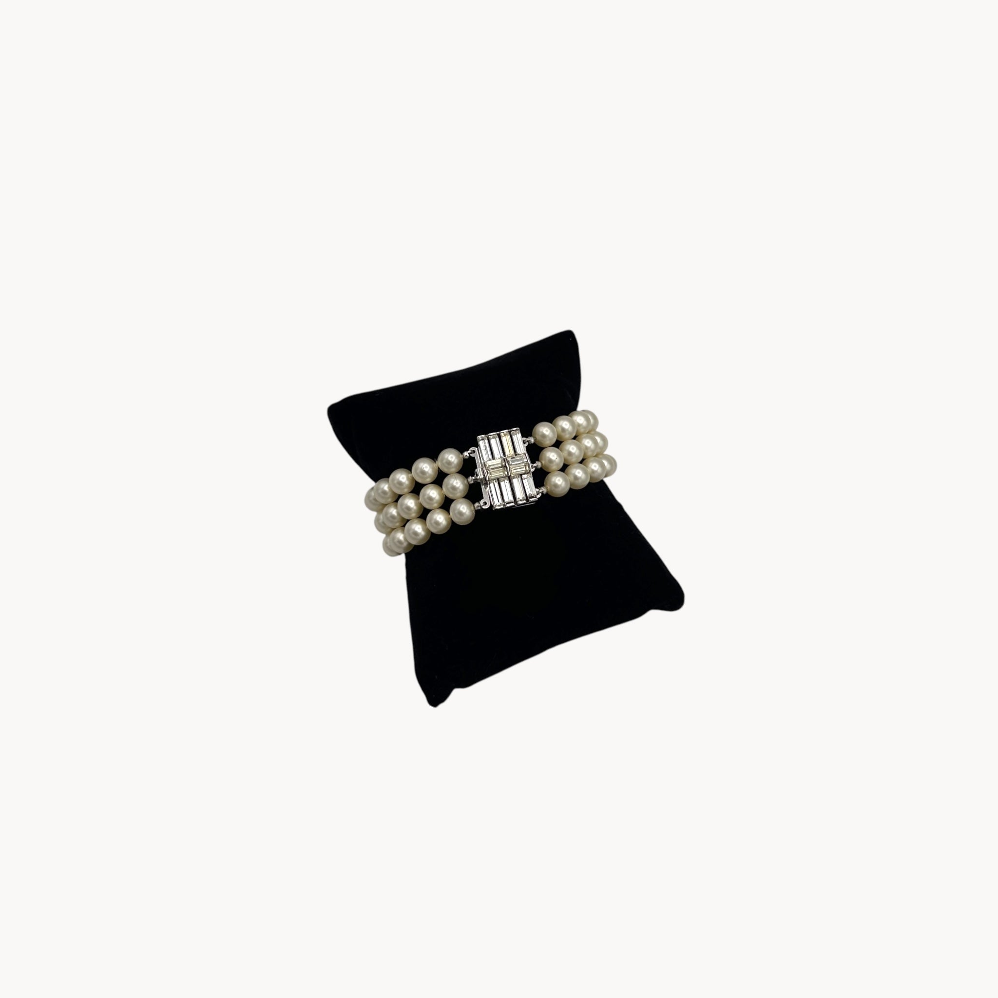 Vintage Trifari faux pearl triple-strand bracelet with baguette crystal clasp, 1950s–1960s bridal jewelry.