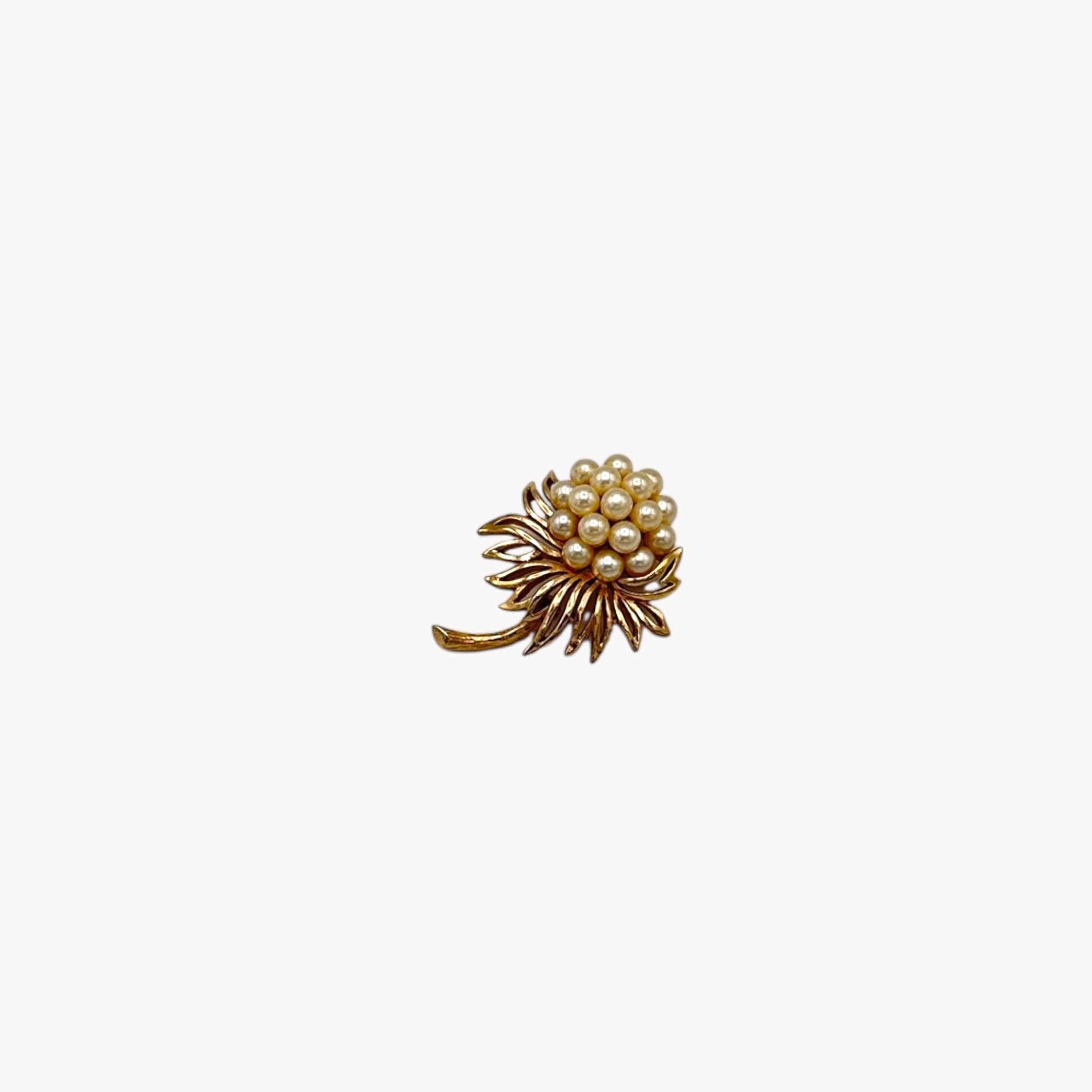 Vintage Trifari gold tone flower brooch with faux pearl cluster.