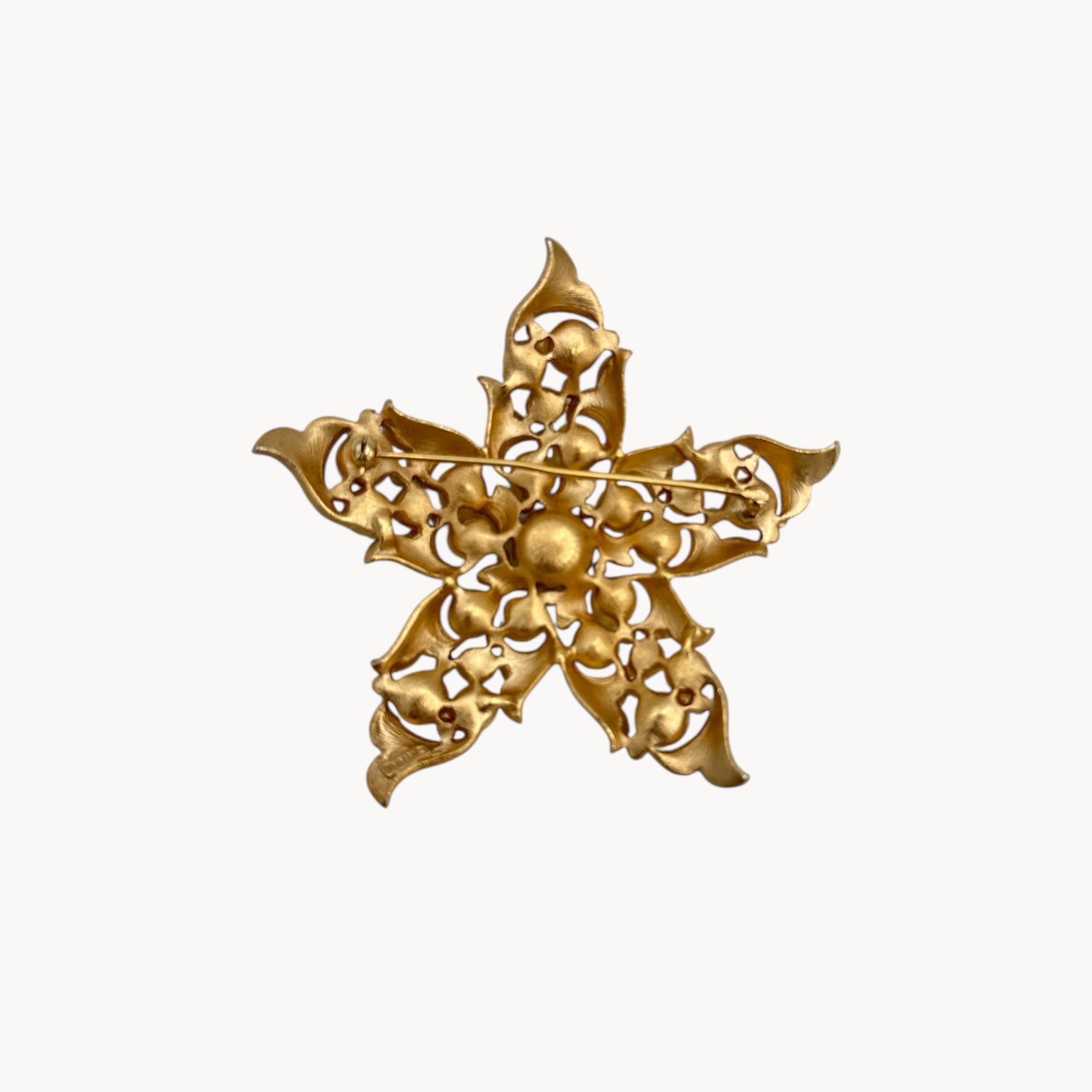Back view of Vintage Trifari floral starfish brooch with faux pearls and rhinestones in gold-tone metal.