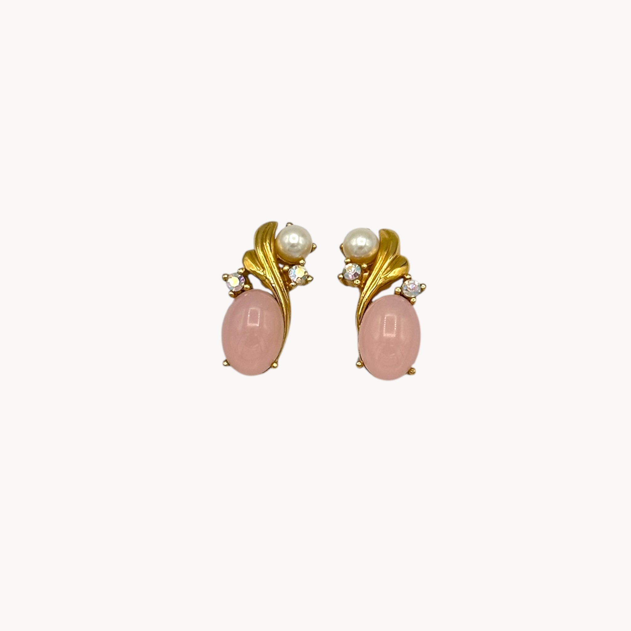 Close up of Vintage Trifari pierced earrings with pink cabochon stones, faux pearls, and crystal accents.