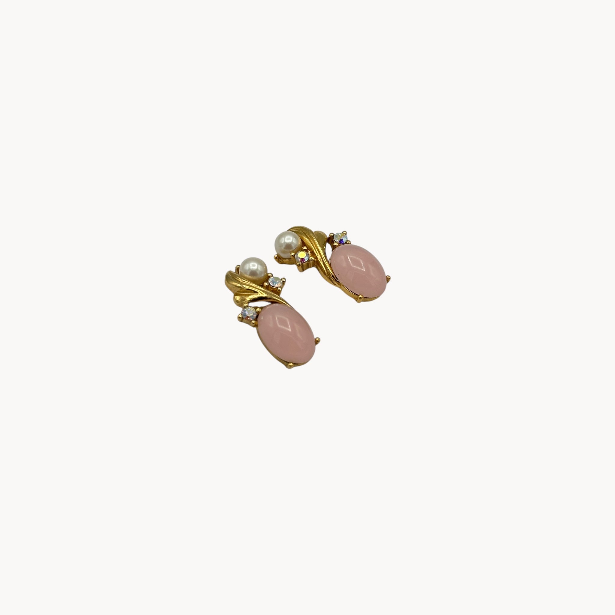 Side view of Vintage Trifari pierced earrings with pink cabochon stones, faux pearls, and crystal accents.