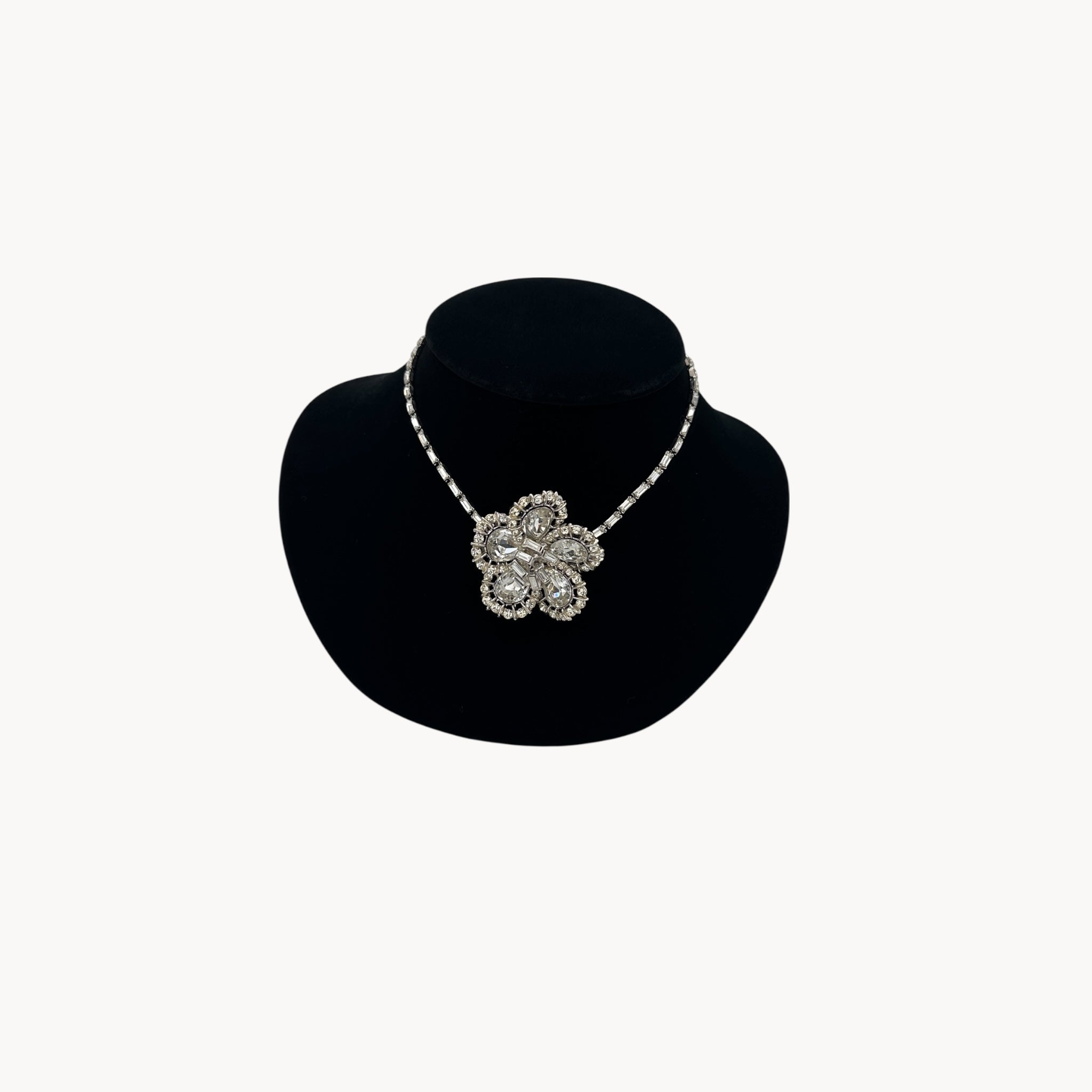 Large Trifari Rhinestone Floral Necklace on black bust.