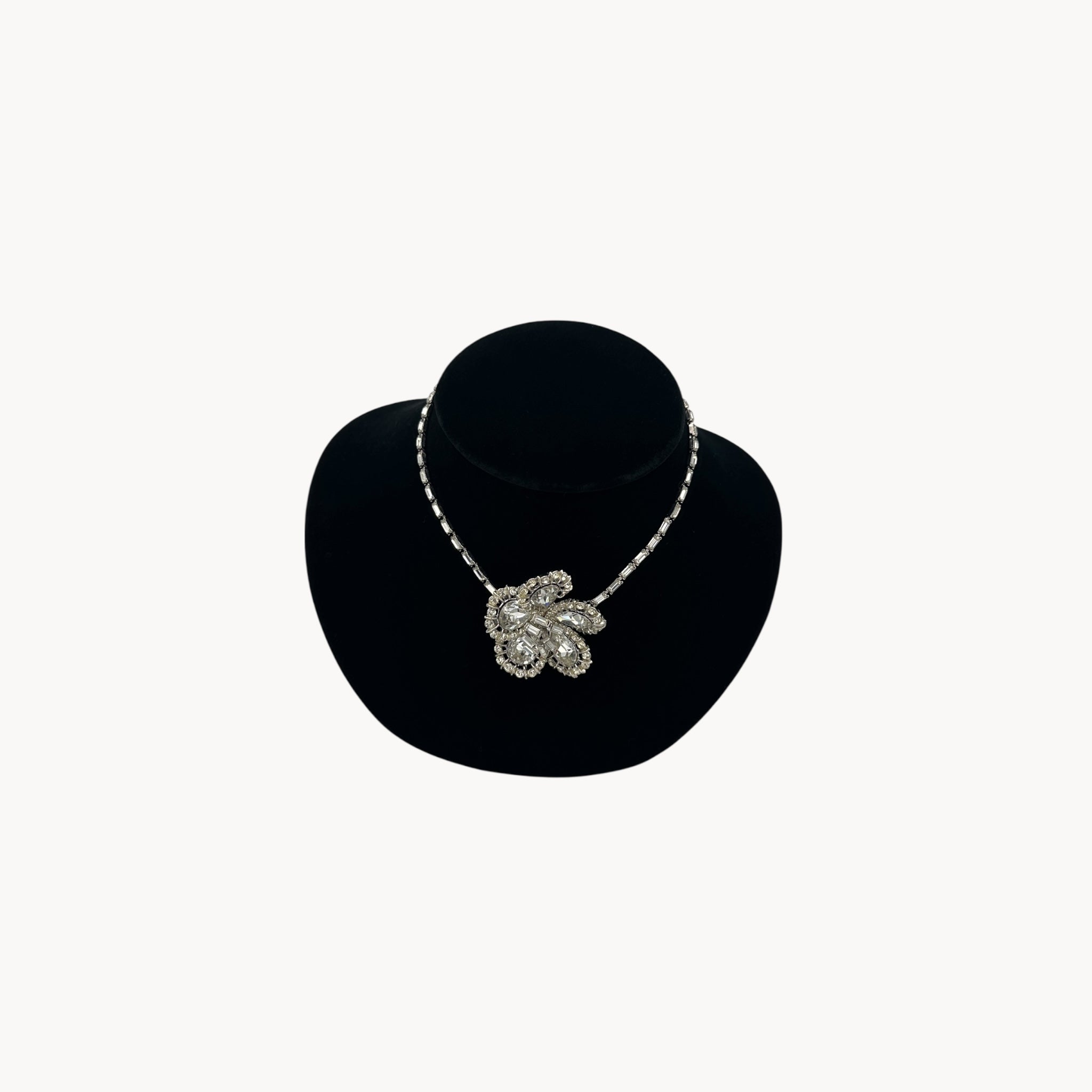 Large Trifari Rhinestone Floral Necklace on black bust.