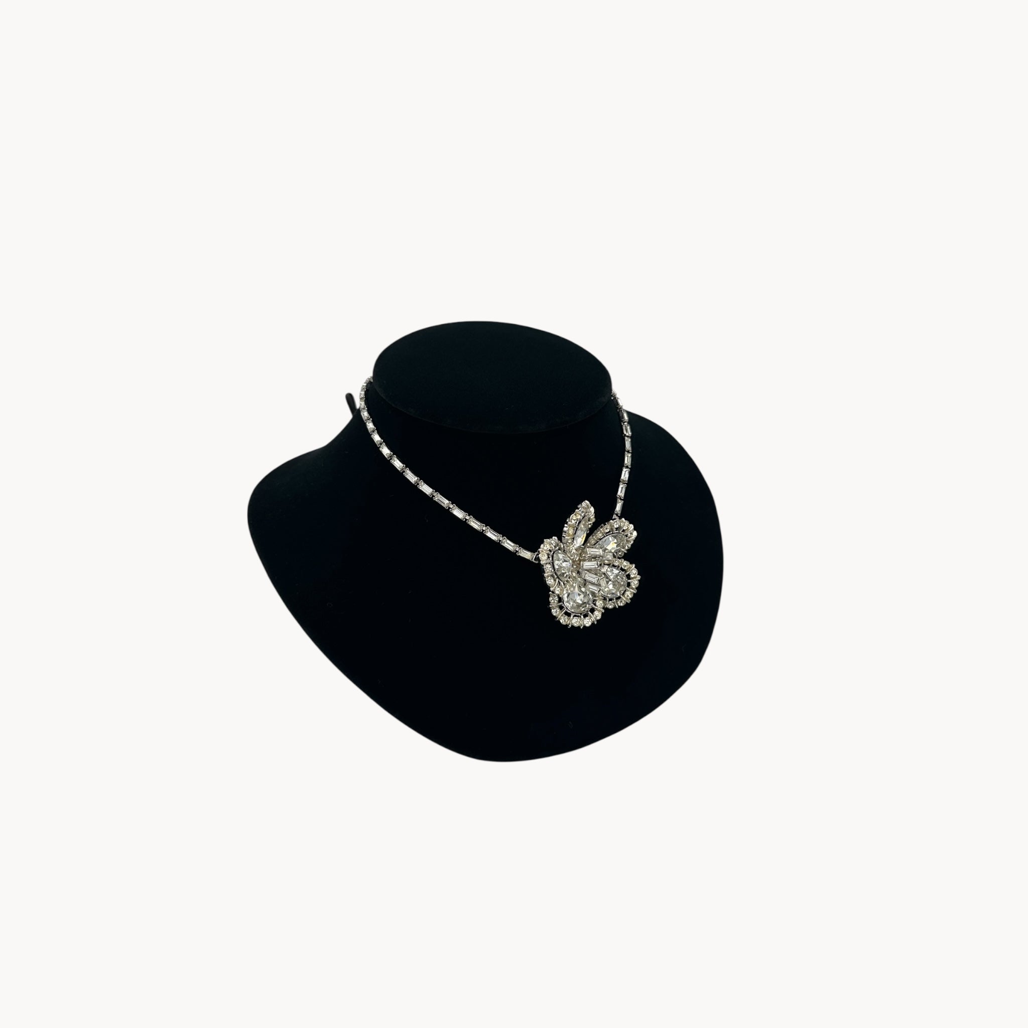 Other side view of Large Trifari Rhinestone Floral Necklace on black bust.