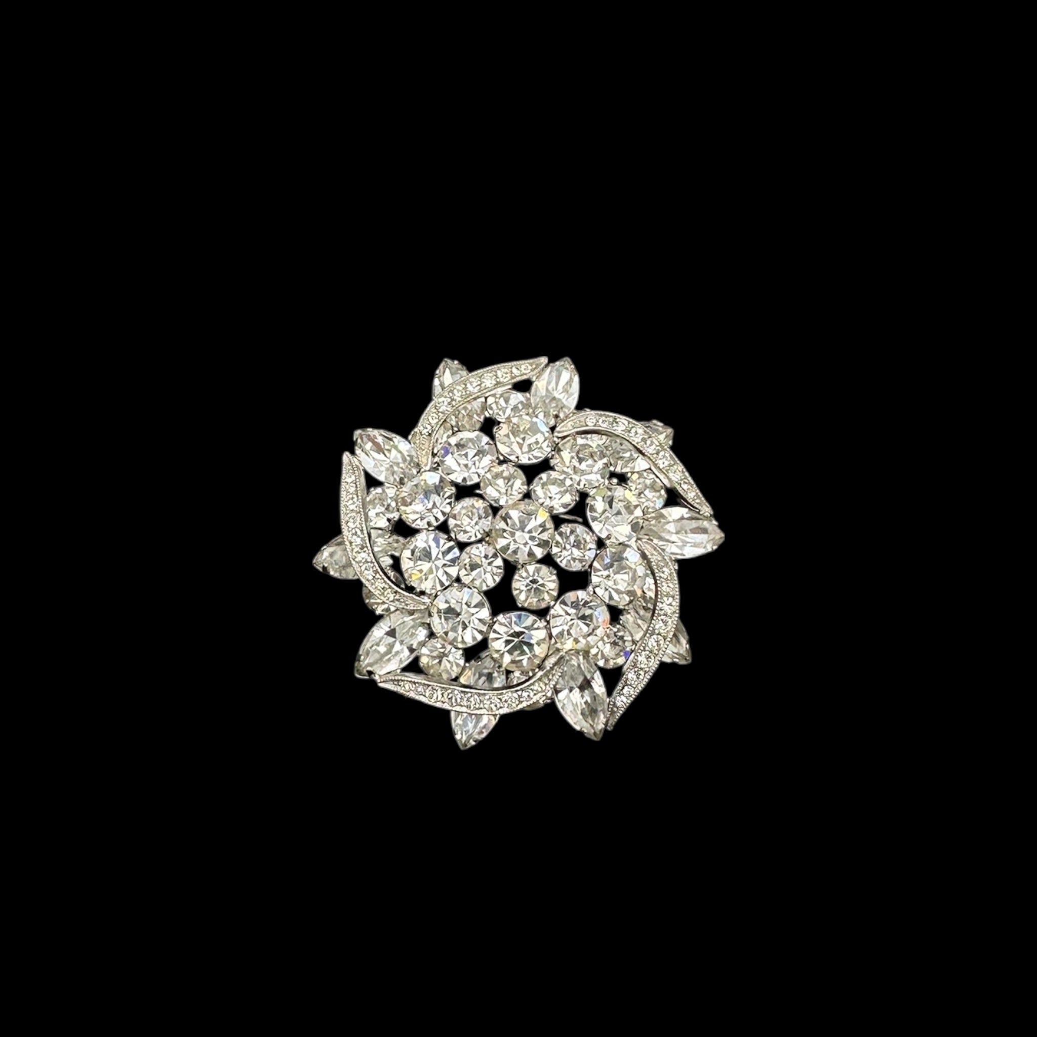 Close up of brooch on black background Weiss rhinestone brooch and earring set with vintage floral design