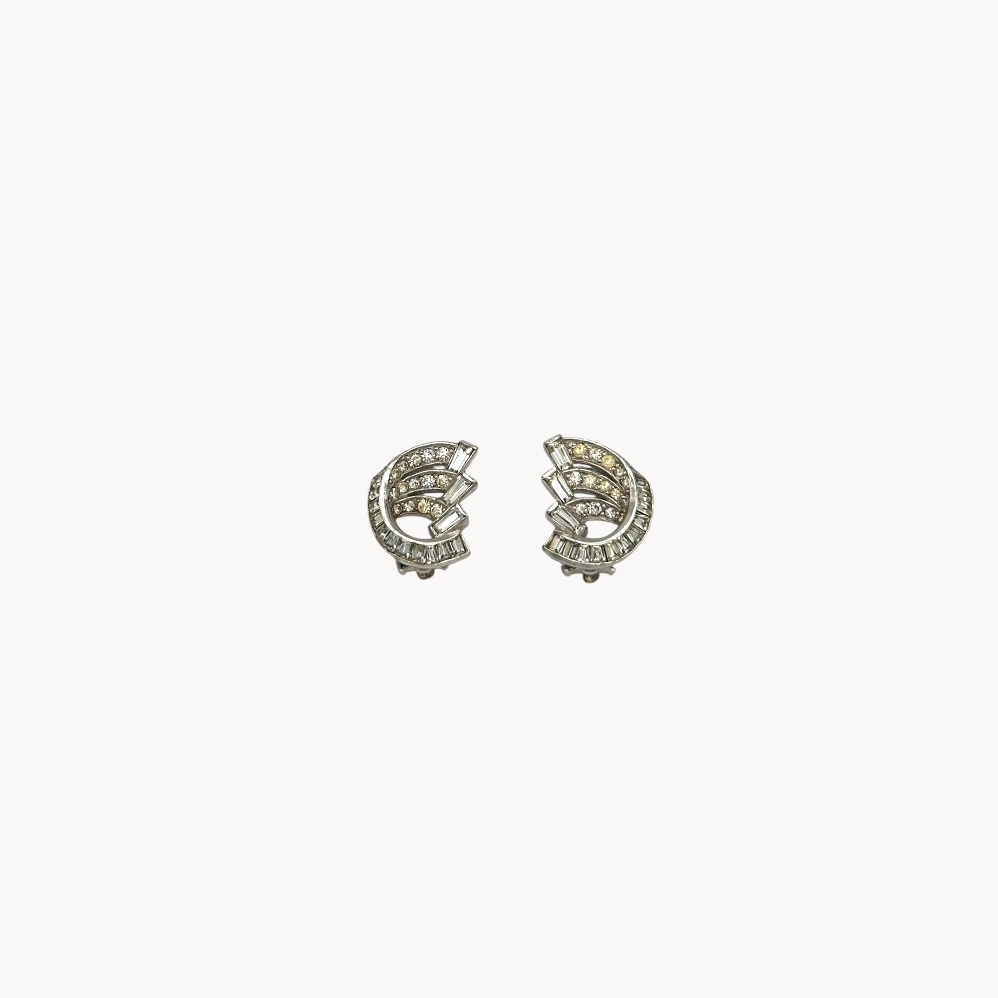 Weiss vintage clip-on rhinestone earrings with baguette and round stones in silver-tone setting.