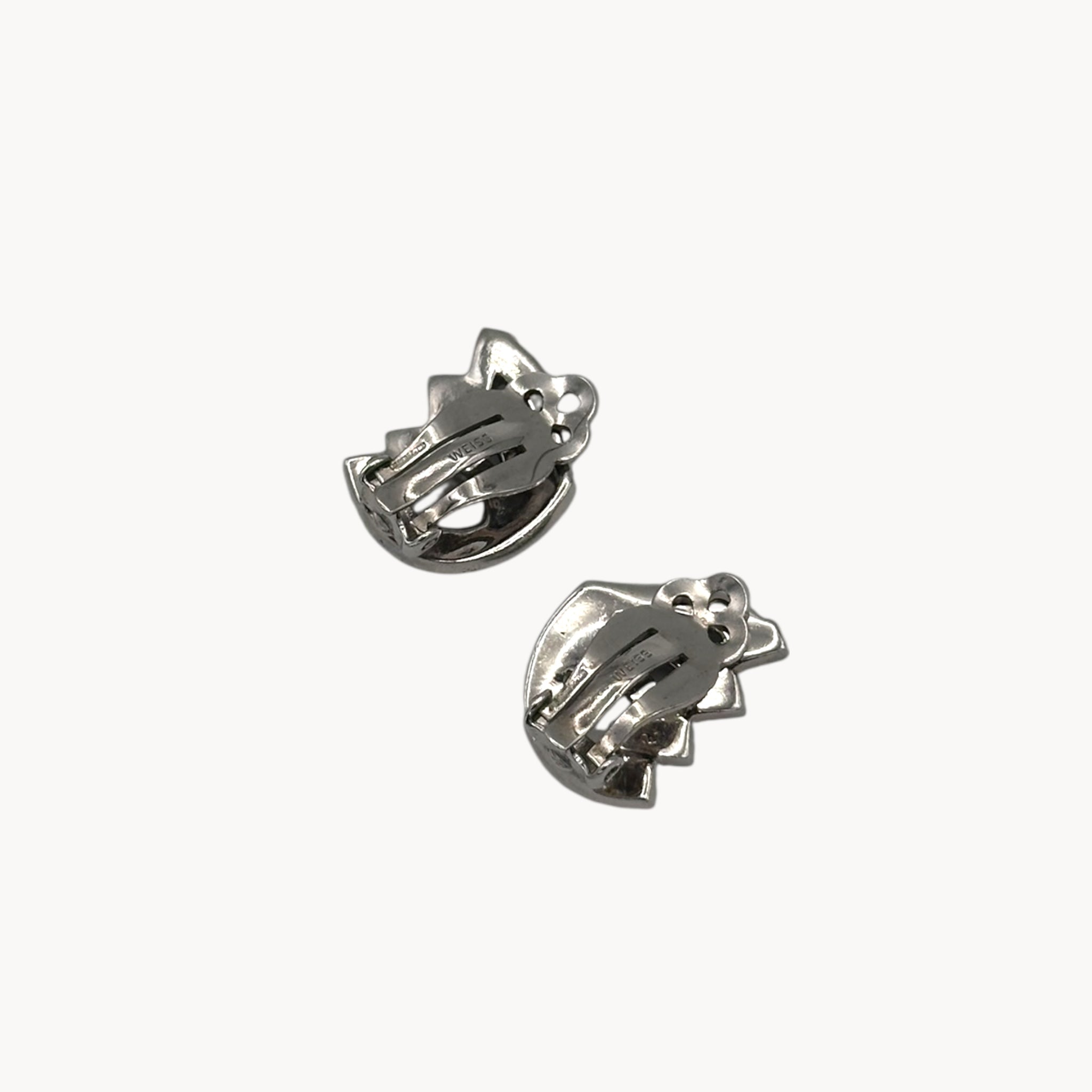 Back of Weiss vintage clip-on rhinestone earrings with baguette and round stones in silver-tone setting.