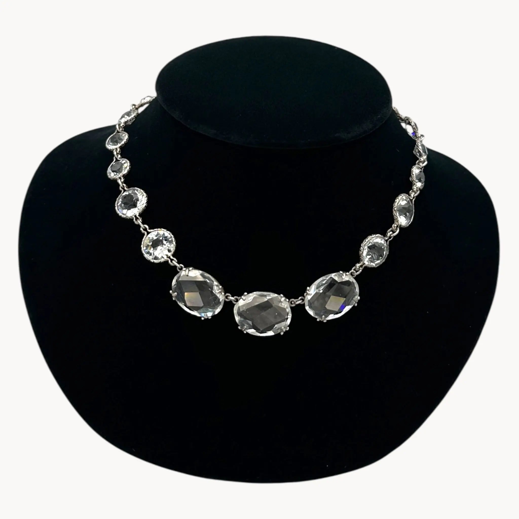 Close up view of Vintage Art Deco crystal necklace with round and oval-cut crystals, stones on black bust.