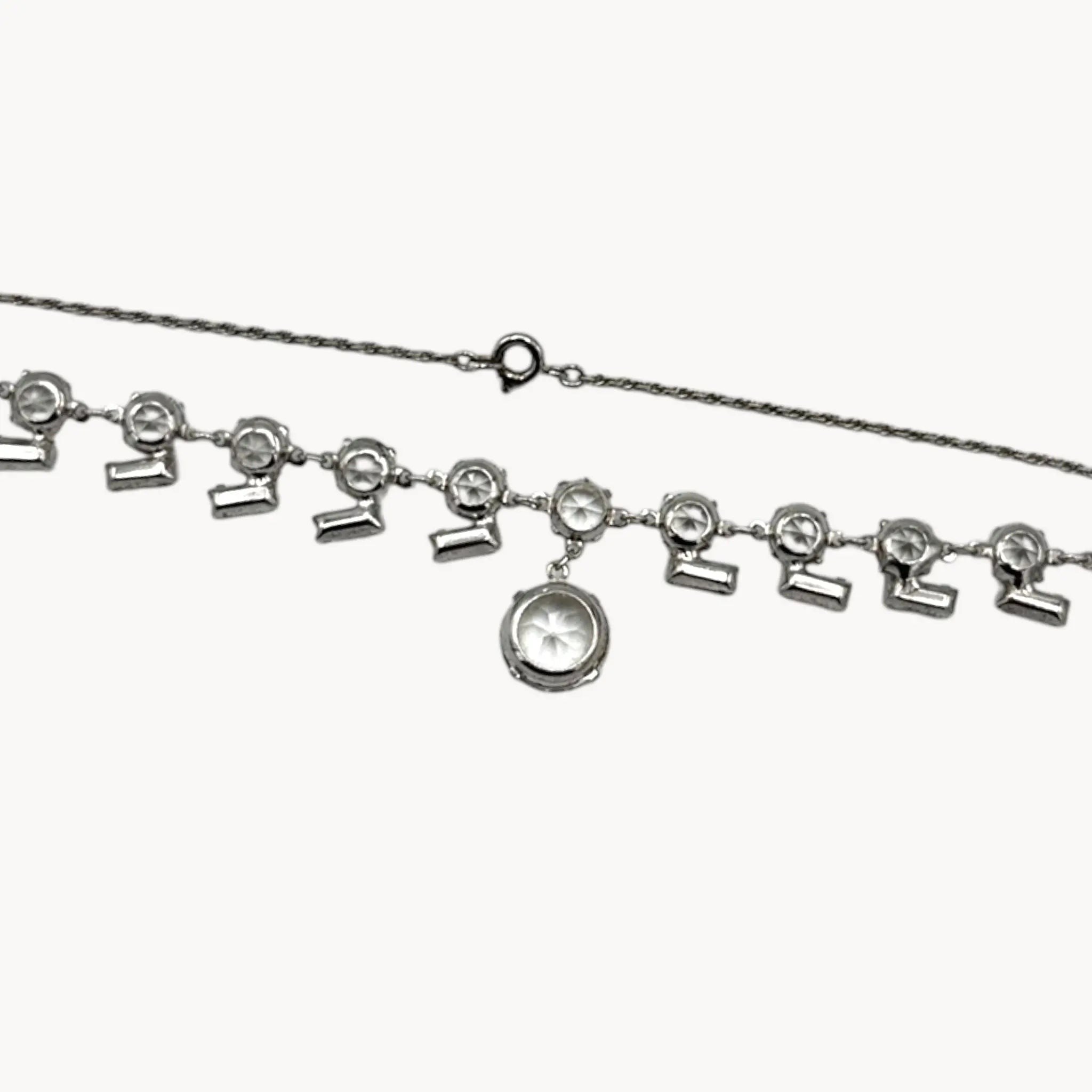 Back view of Art Deco sterling silver clear crystal necklace with geometric design and round drop.