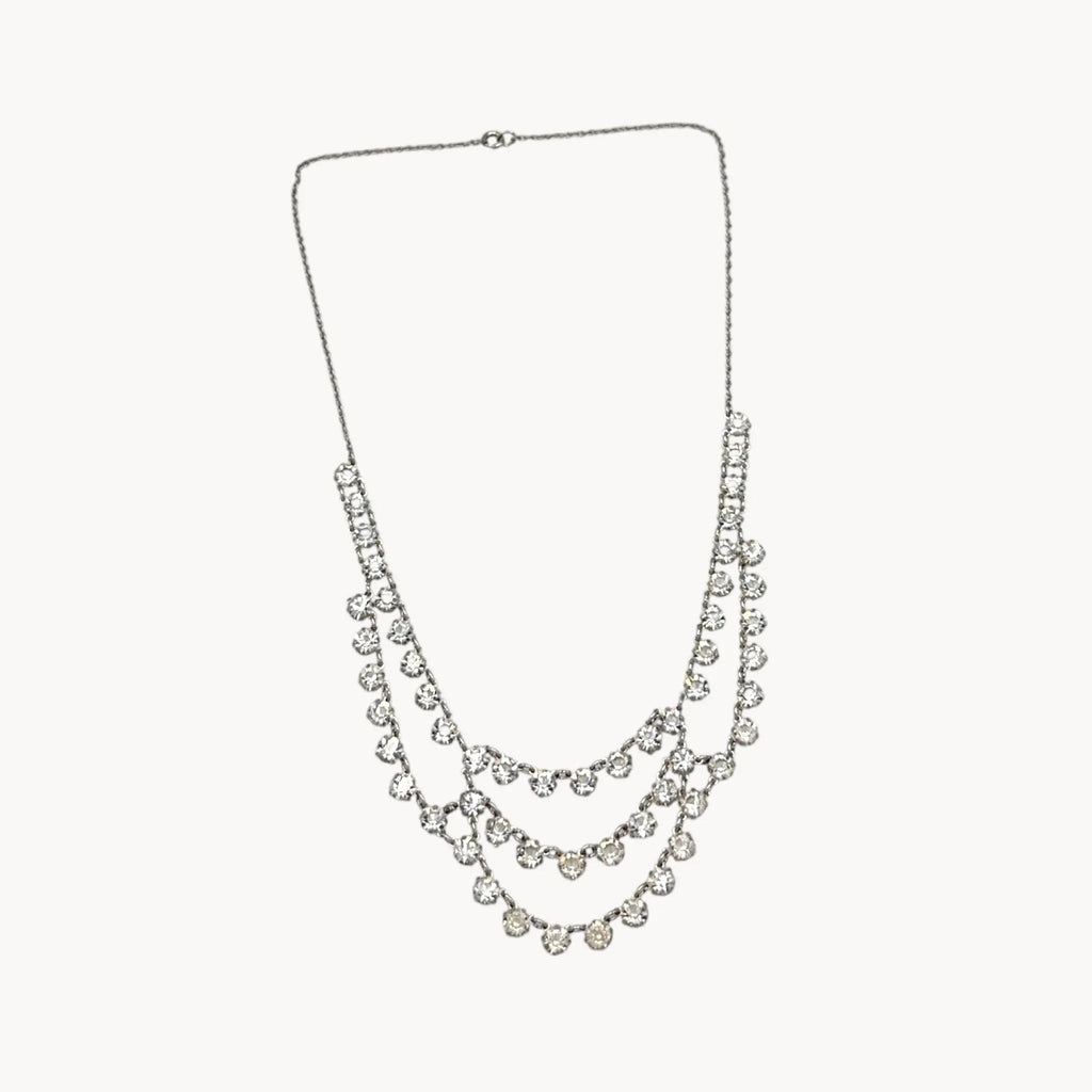 Art Deco style 12K gold-filled rhodium plated crystal draped necklace on white background.