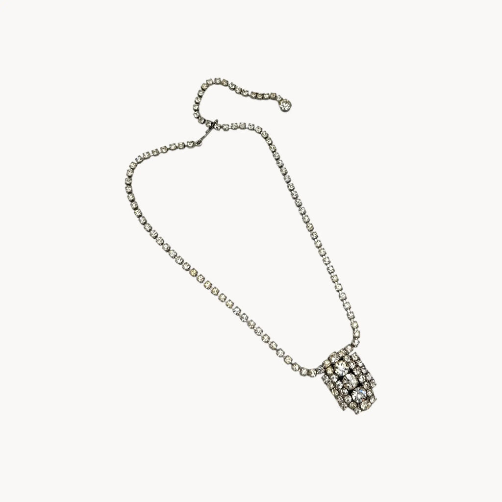 Against white background 1950s Art Deco style rhinestone necklace with geometric pendant drop, vintage mid-century bridal jewelry